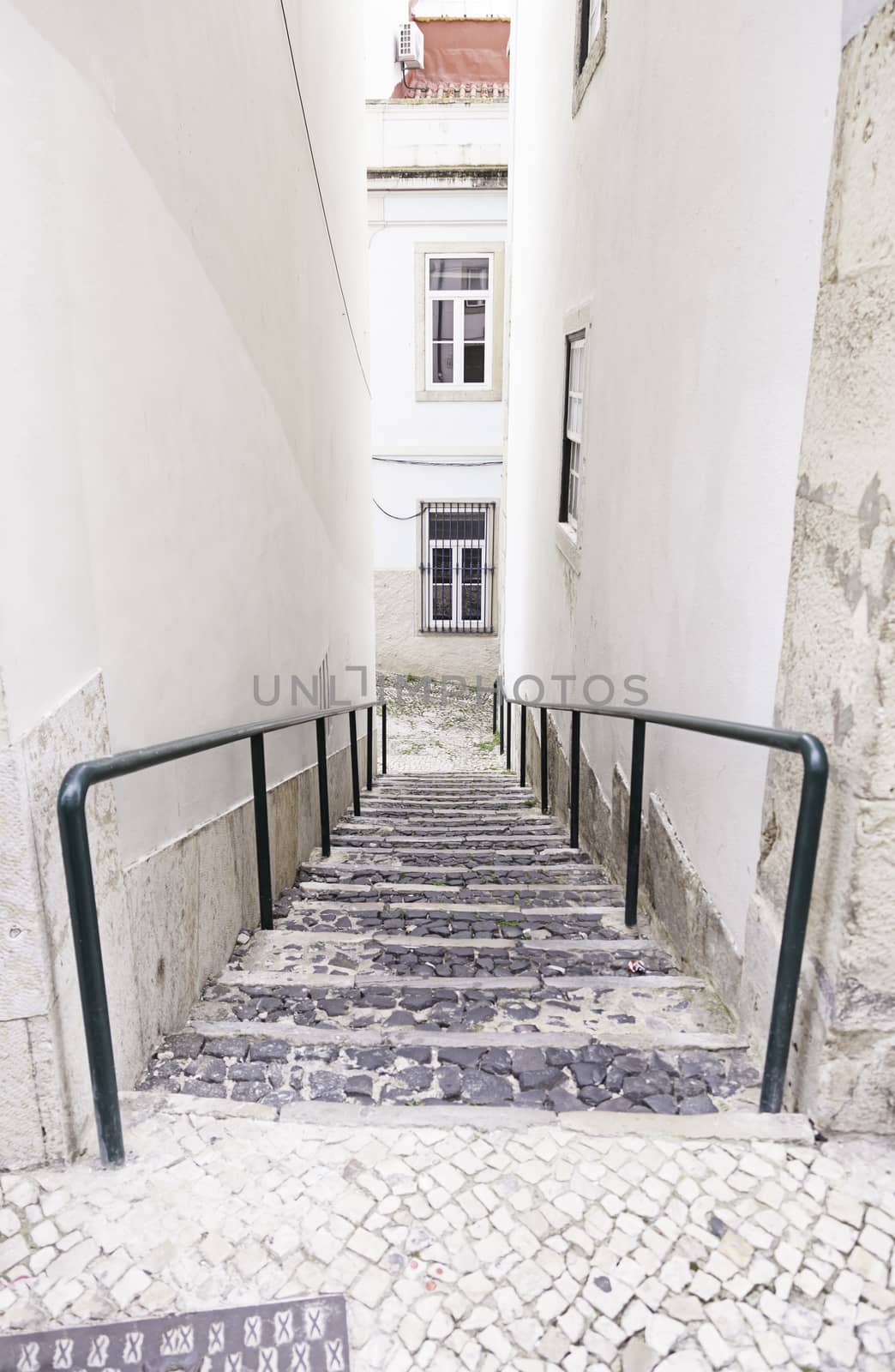 Old stone stairs in Lisbon, detail of stairs in an old street in an old neighborhood in Portugal
