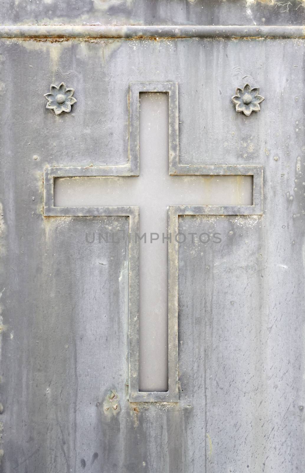 Old rusty metal cross, detail of an old cross on a metal wall, cemetery