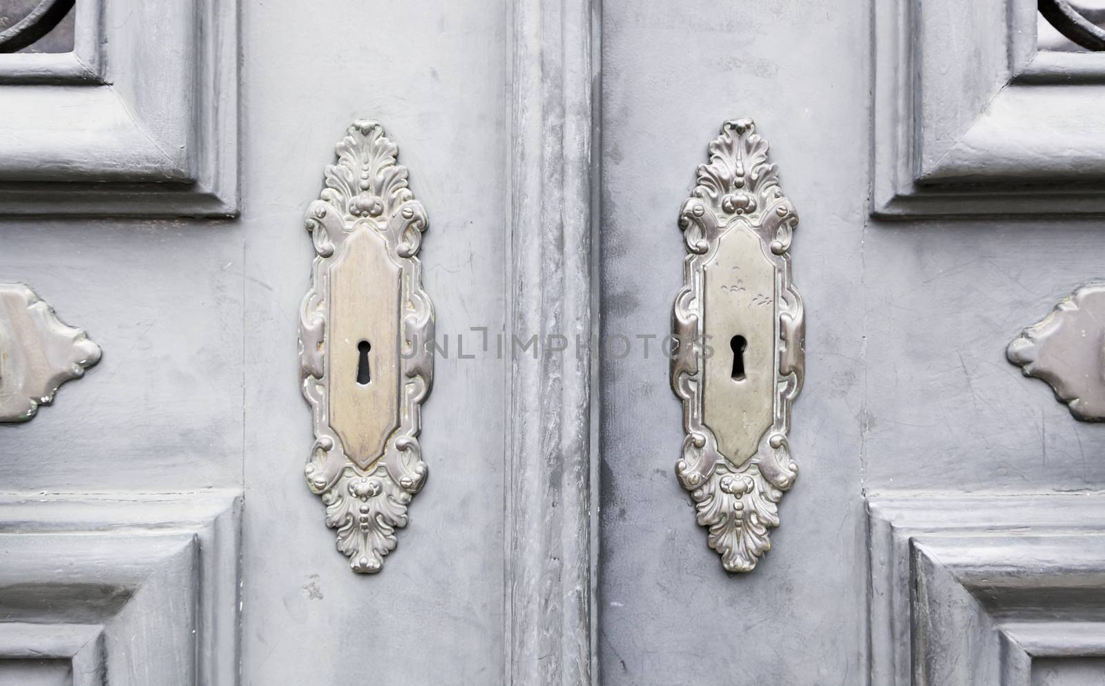 Wooden door with metal knockers, door detail of a decorated, safety and security