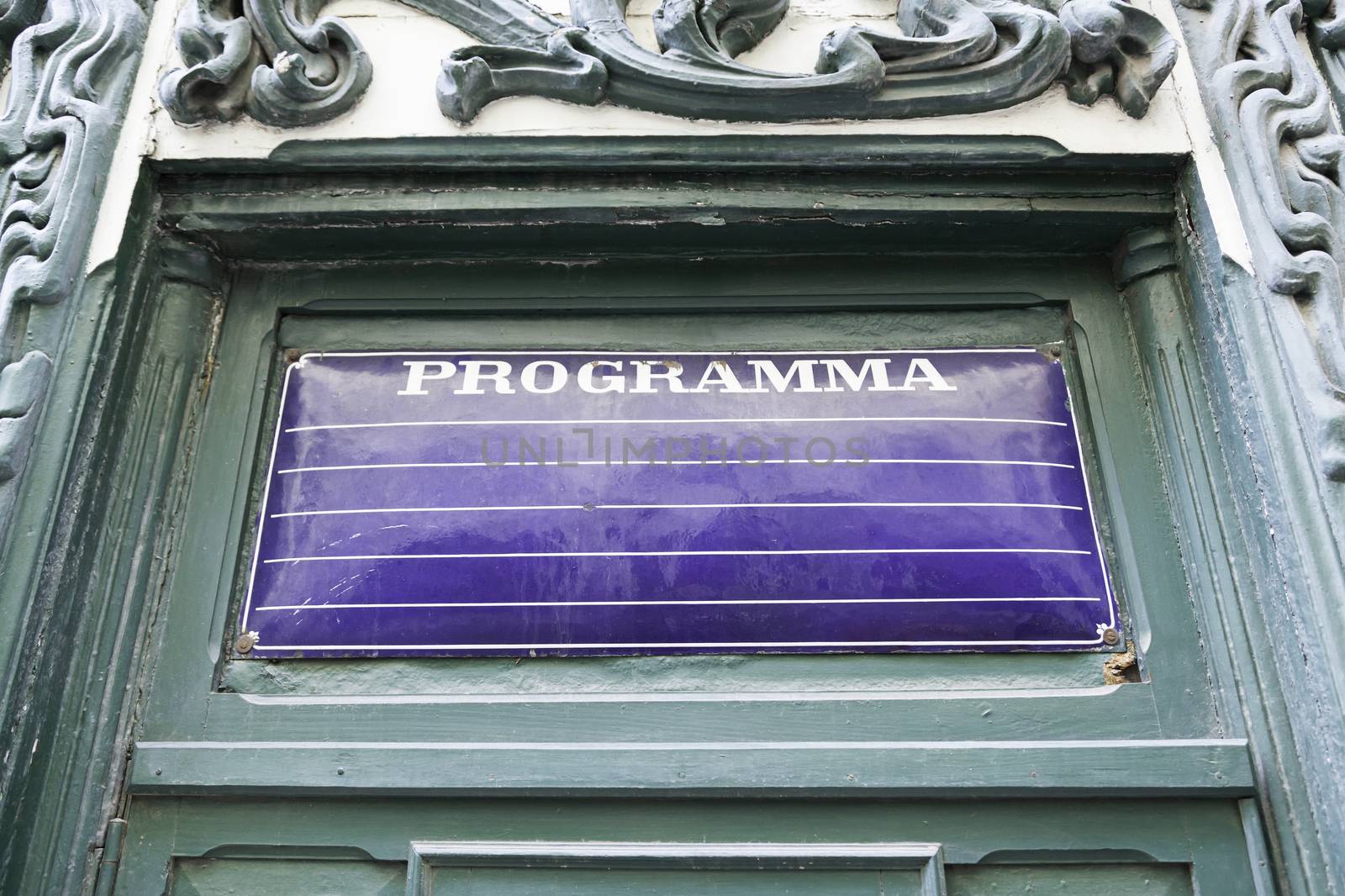 Poster program on a wall, detail of an old empty billboard on a street