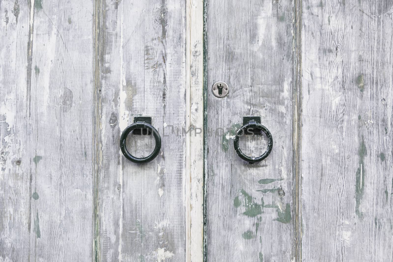 Old wooden door, detail of an old door damaged, security