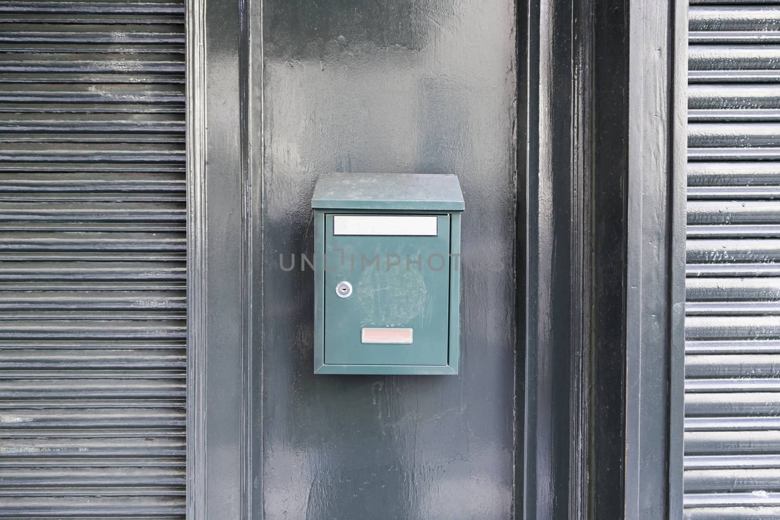 Green mailbox on a wall, detail of a mailbox post cartes, correspondence