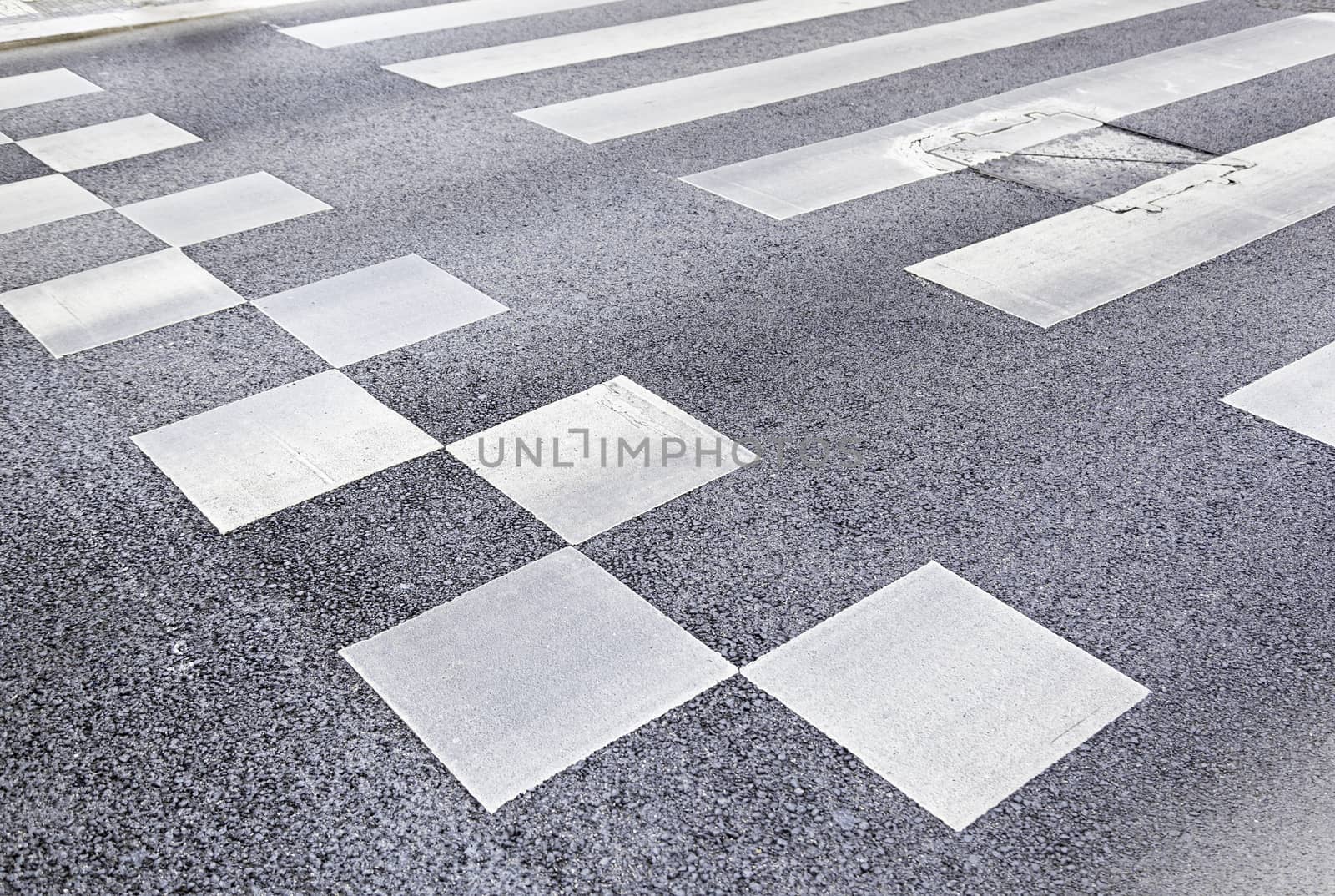 Zebra crossing in the city, detail of a crosswalk on a road, asphalt and safety