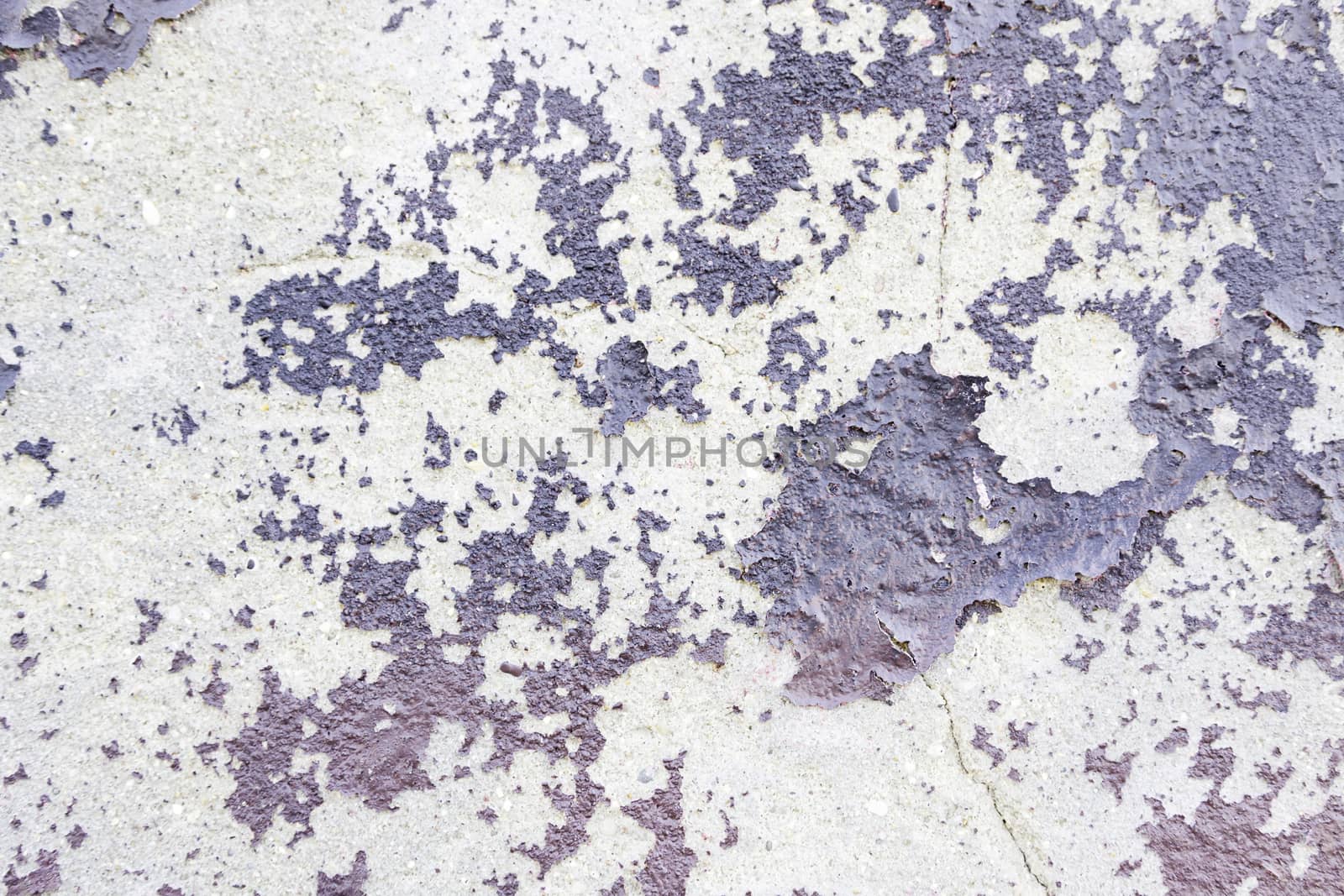Abandoned peeling painted wall detail of an old ruined wall, background with texture
