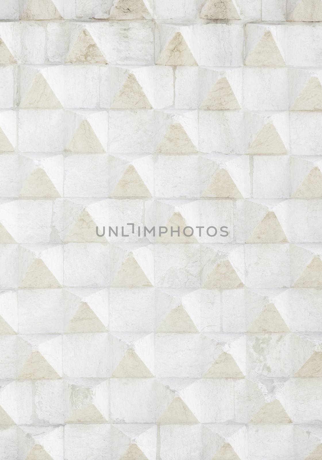 Stone wall with reliefs of triangle, background