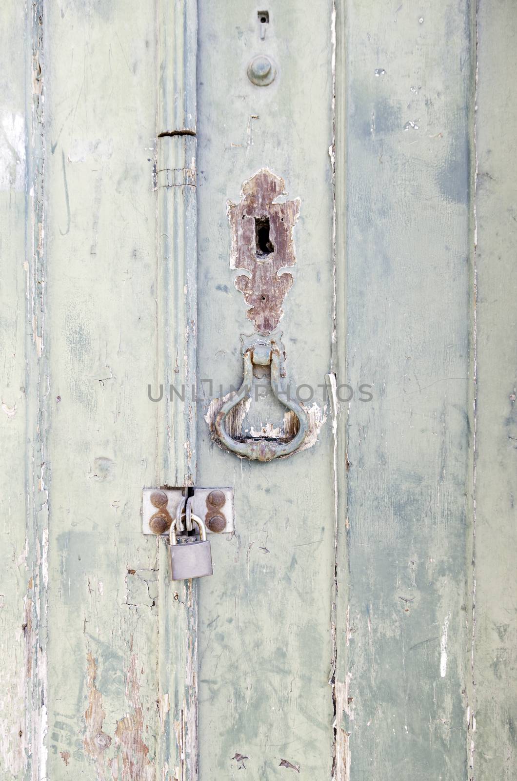 Door closed with wooden decoration, detail of a closed door with padlock, protection and security