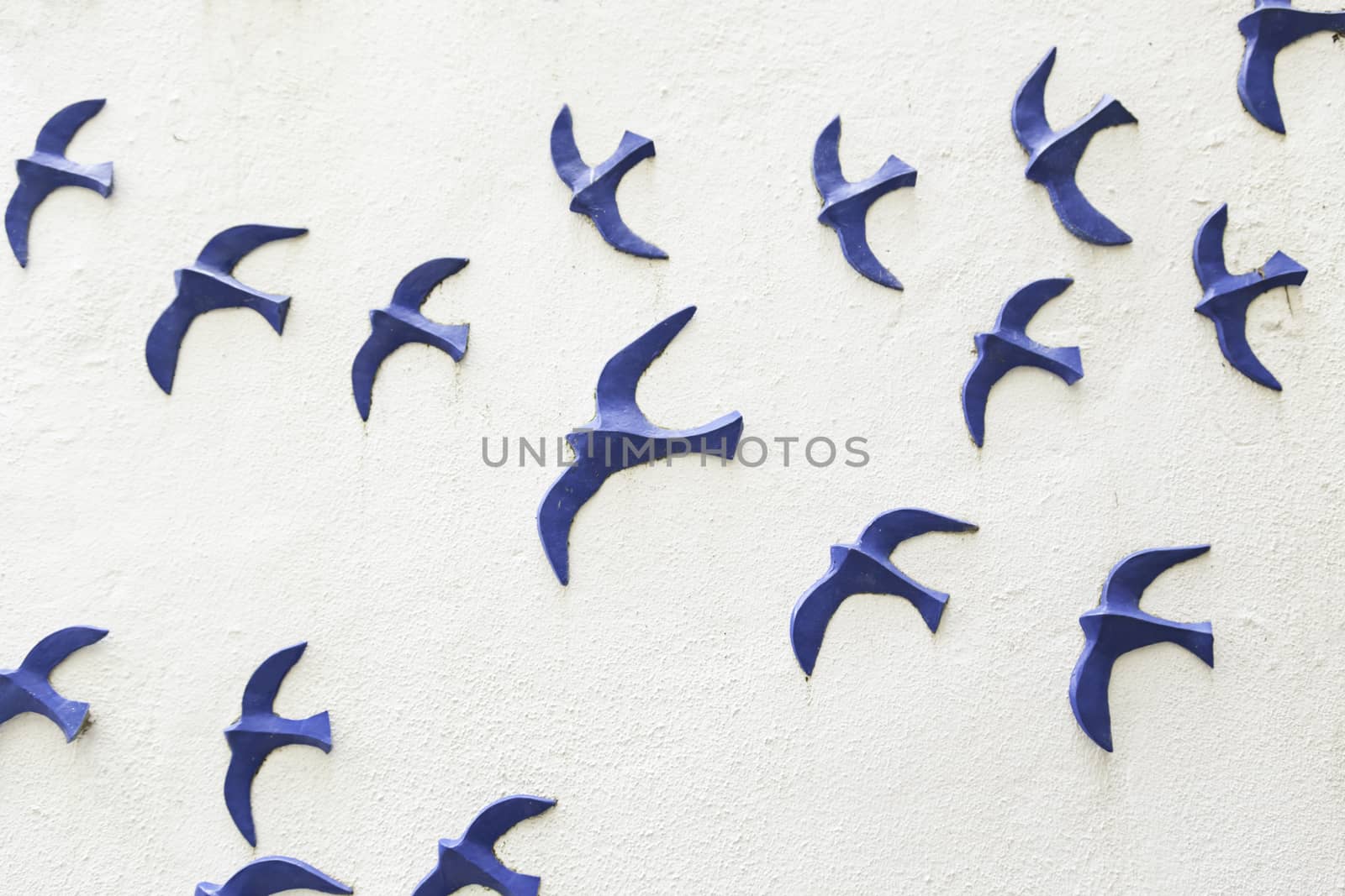 Birds on a wooden wall, detail of a wall decorated with figures of blue birds