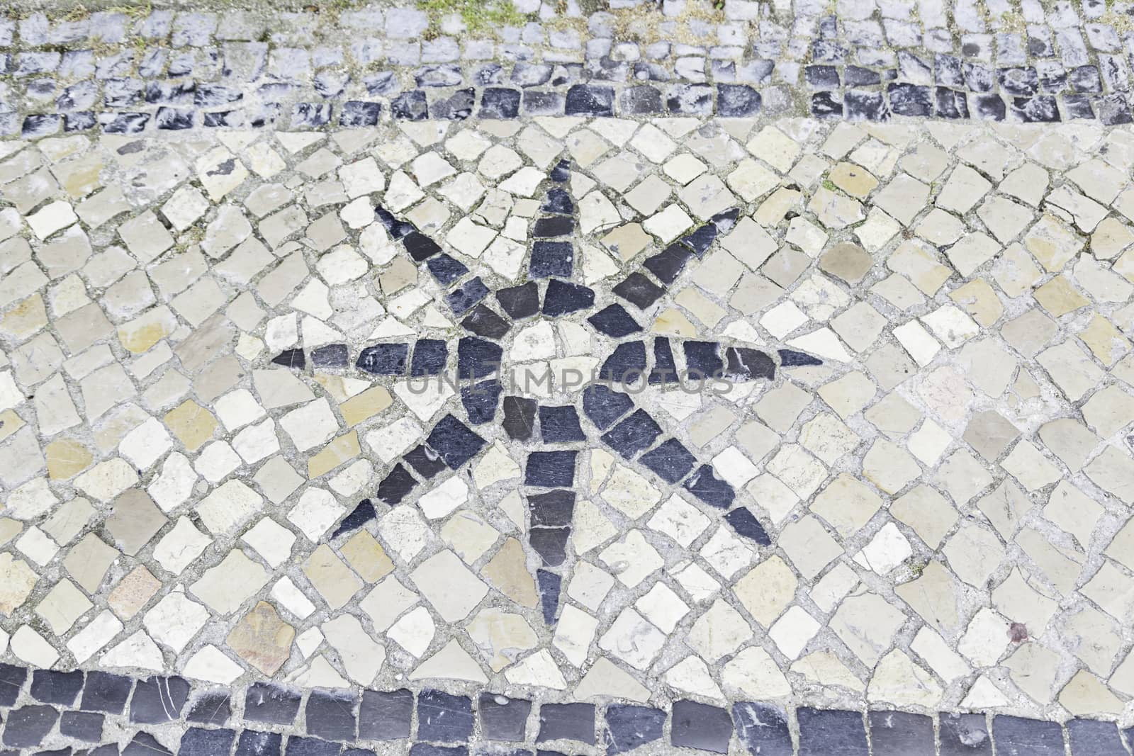 Star typical tiles from Lisbon, detail of a mosaic in a typical tourist street