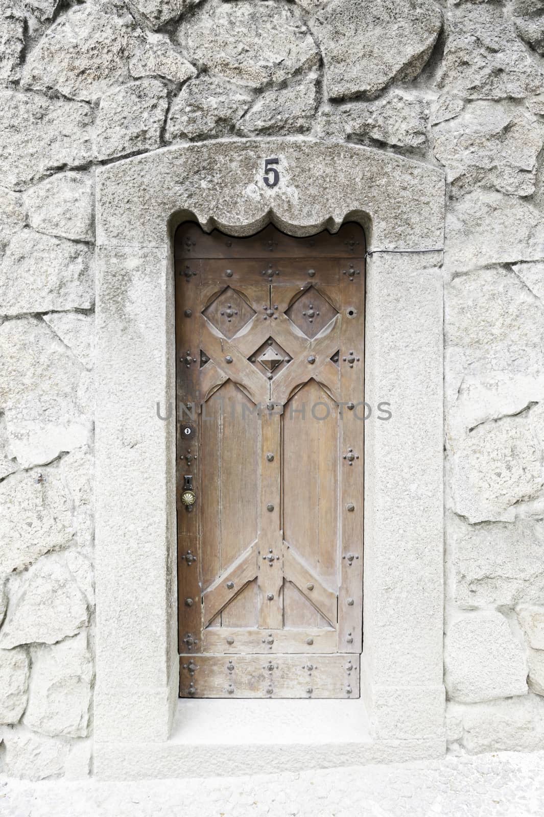 Old wooden door in a church, detail of a decorated door, protection and security