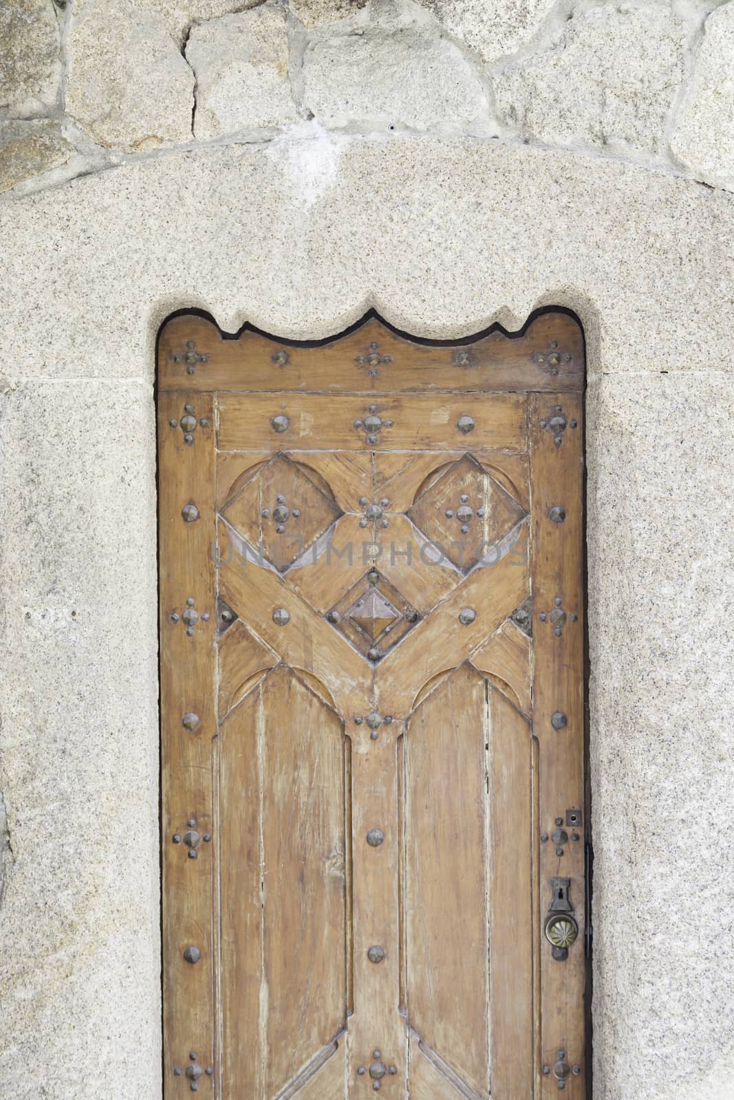 Old wooden door in a church, detail of a decorated door, protection and security