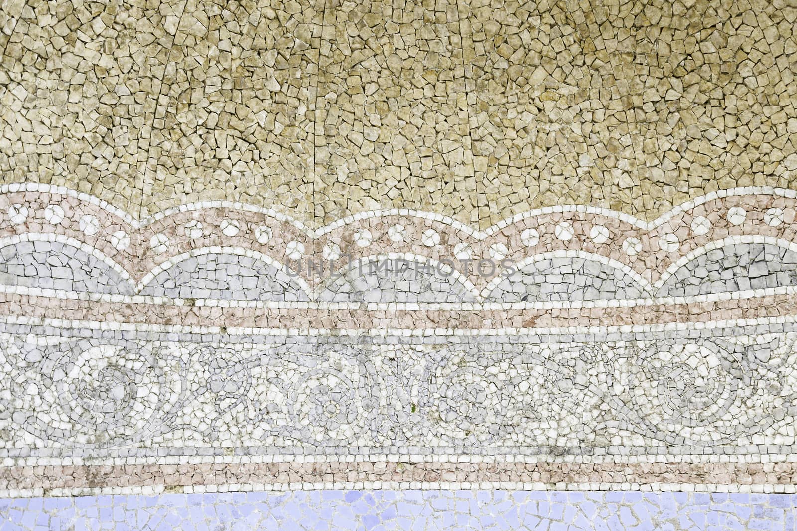 Old stone mosaic, detail of a wall decorated with colored stones, textured background