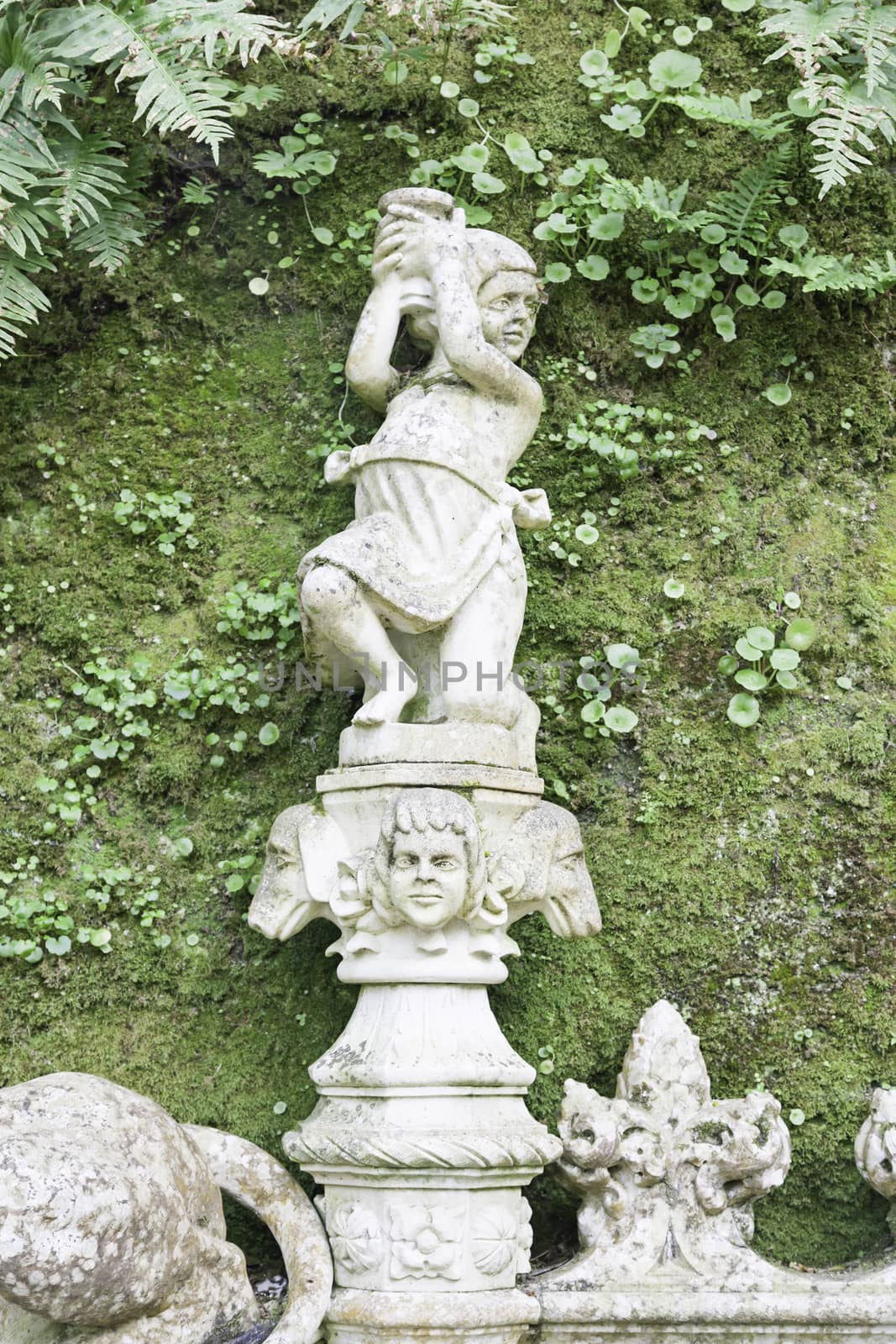 Stone statues in a garden in Sintra, detail of art in stone outdoors, tourism and art