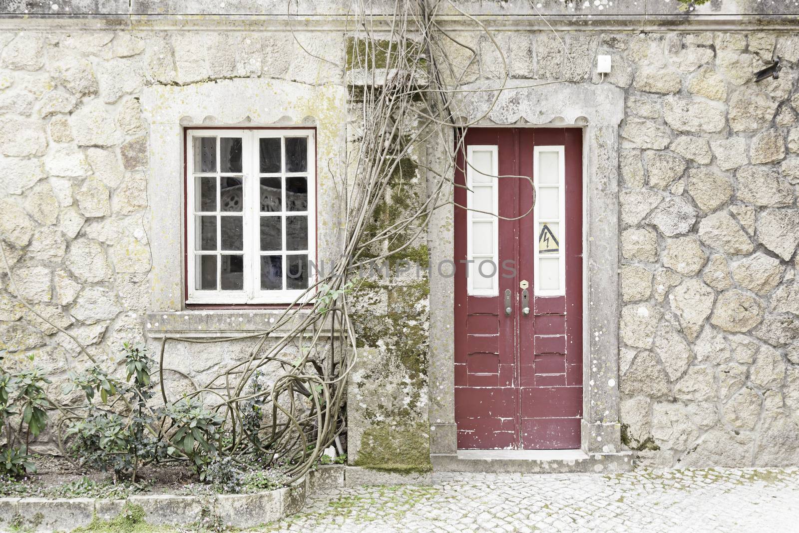 Door and window old, abandoned, detail of the facade of an old stone house