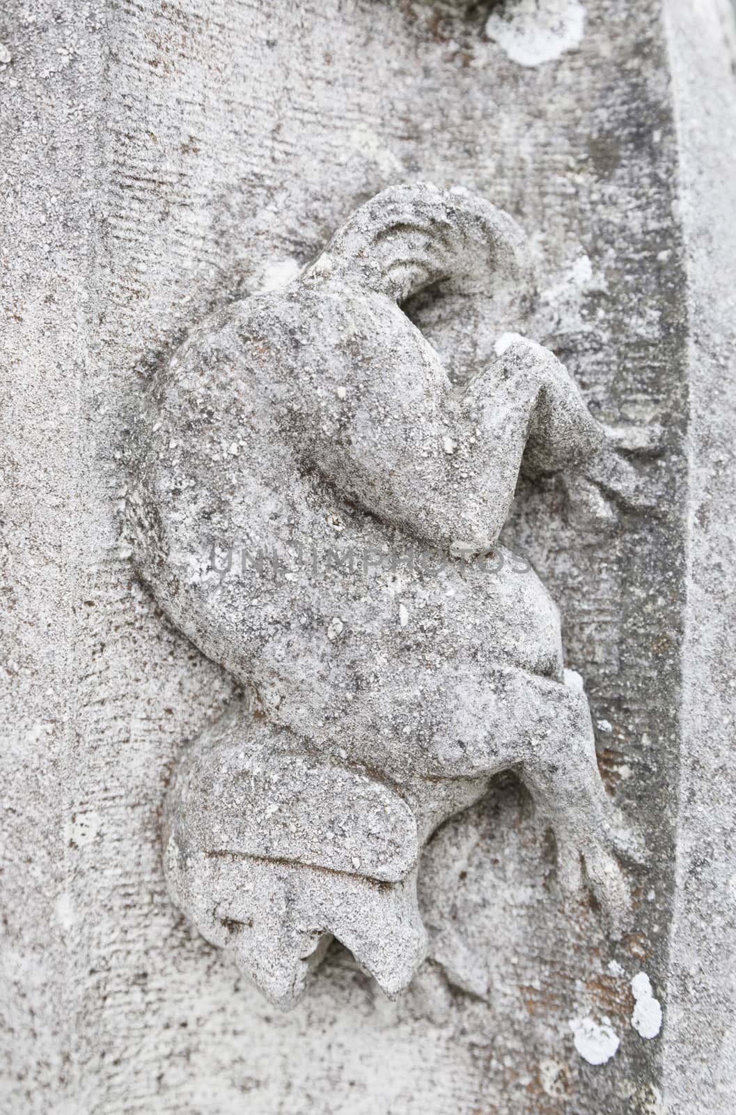Old stone gargoyle in Portugal, detail of art in an old building, medieval