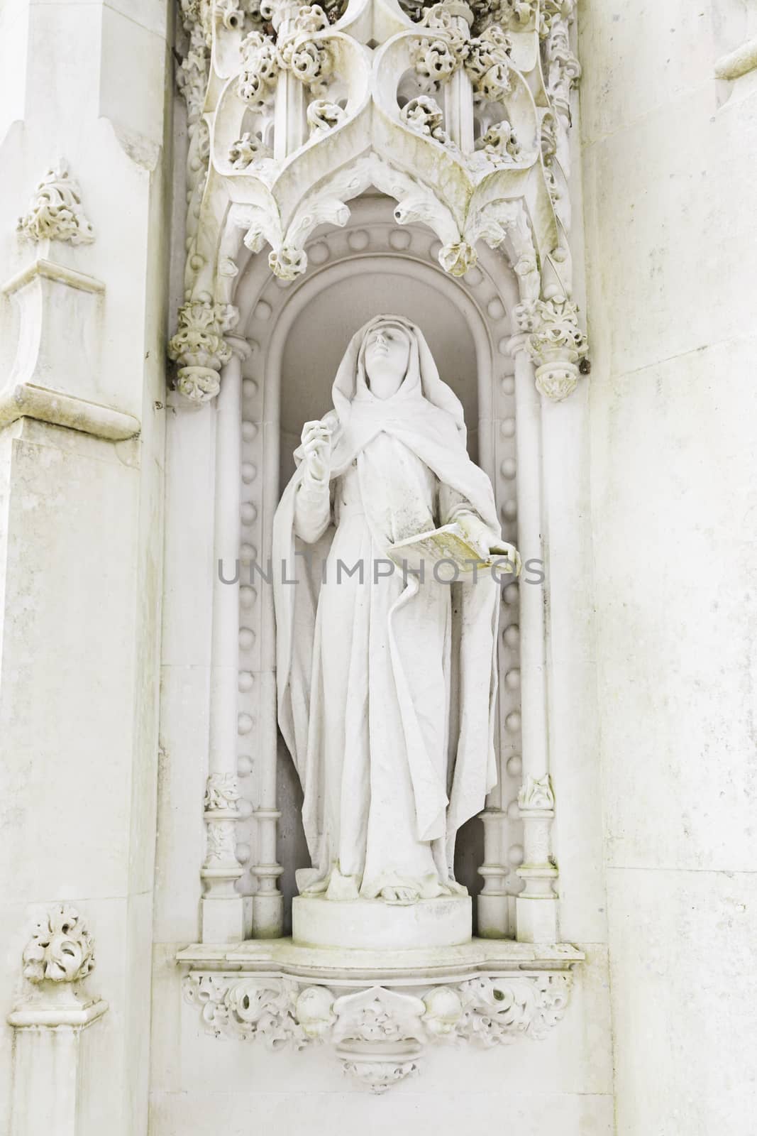 Statue of a virgin in stone, detail of religious art, Christian monument