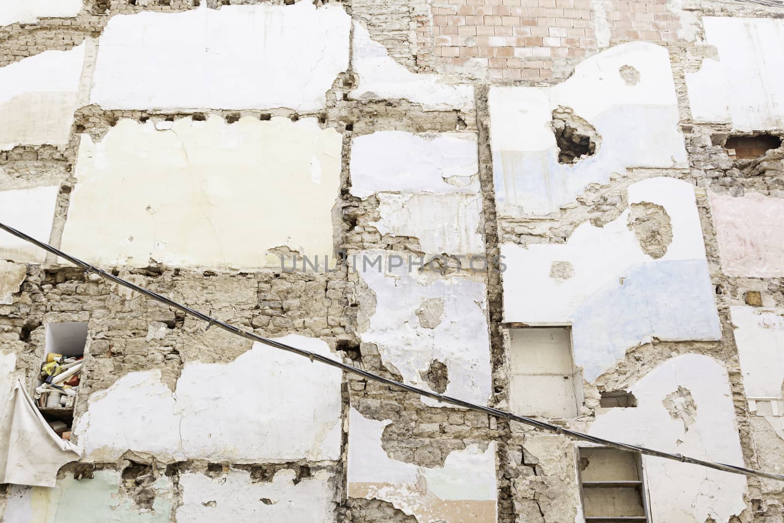 Wall of a ruined house, detail of a ruined building in the city, demolition and destruction