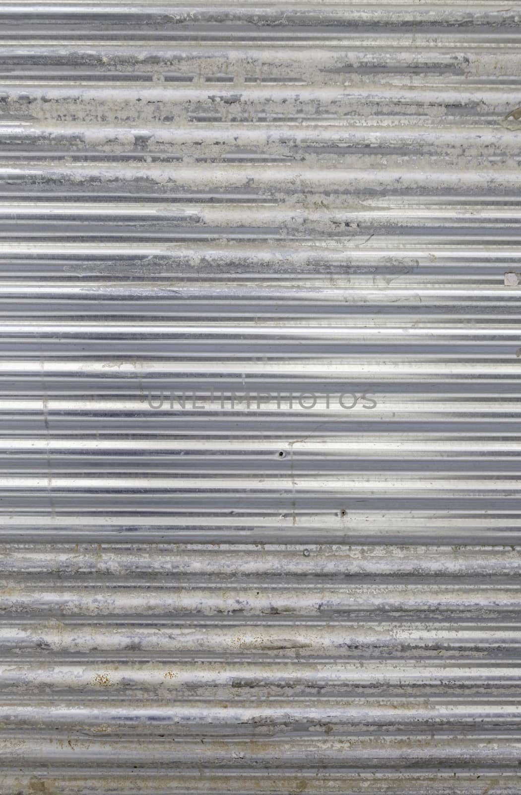 Dirty and damaged metal wall, detail of a metallic textured background