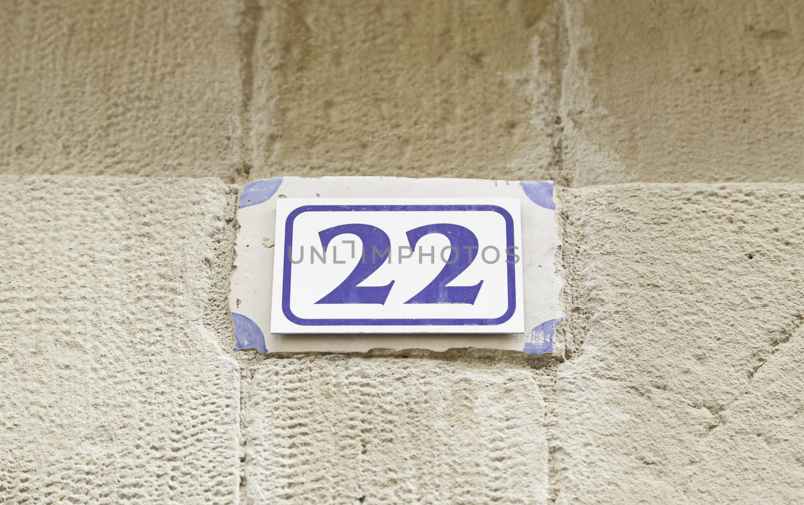 Number twenty on a wall, detail of a number of information on a street, text and number, even number