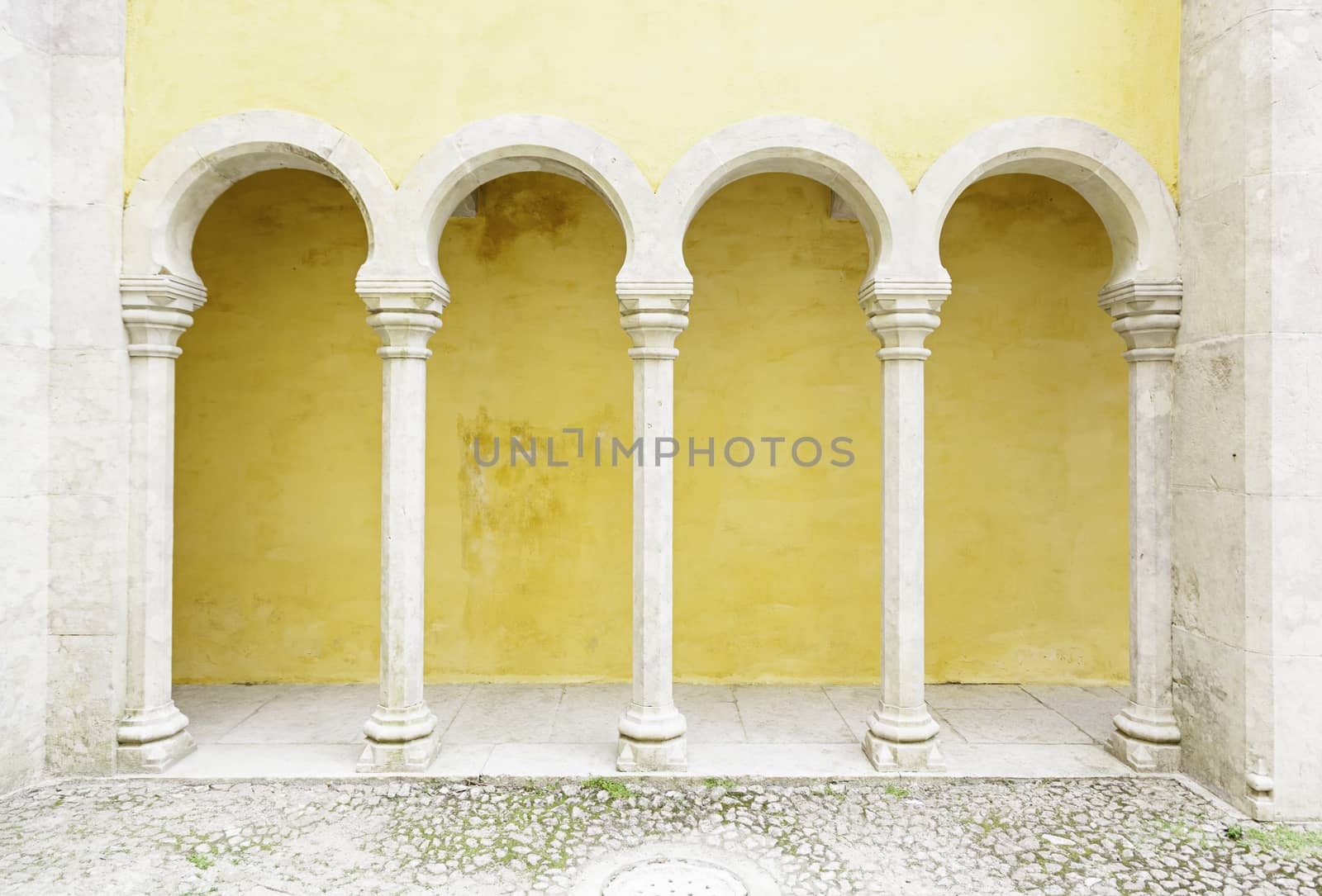 Ancient yellow arches in the Pena Palace, detail of ancient architecture, heritage of humanity, tourism