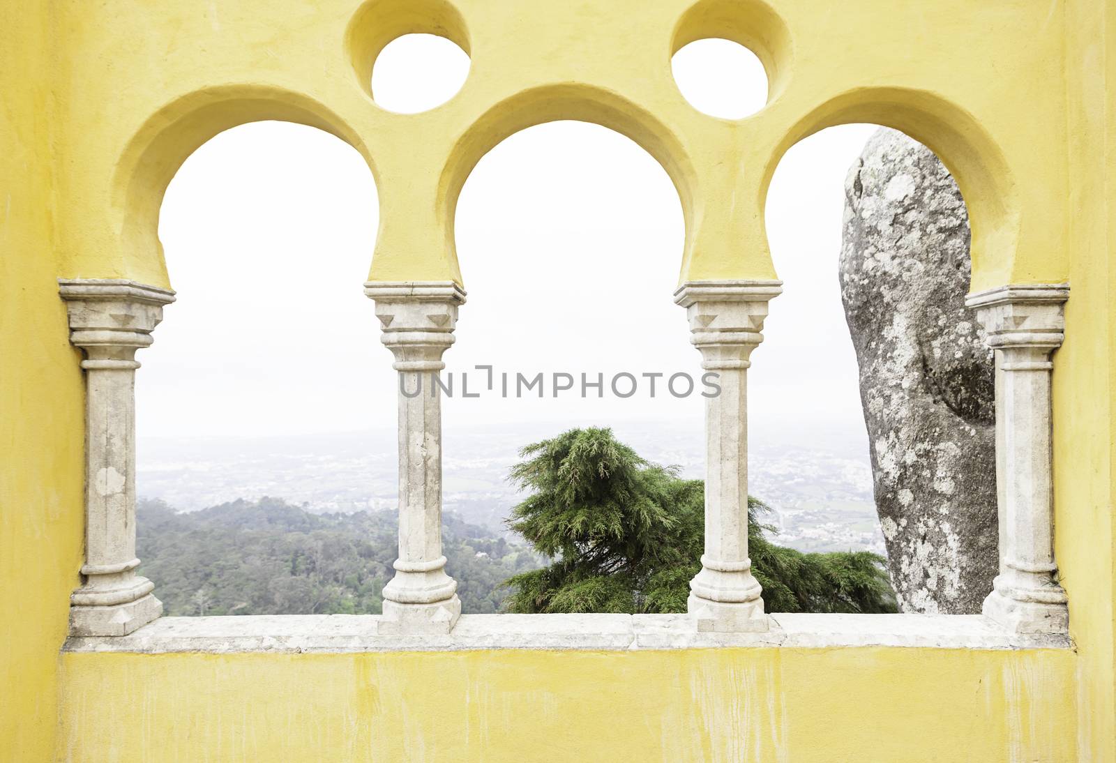 Ancient yellow arches in the Pena Palace, detail of ancient architecture, heritage of humanity, tourism