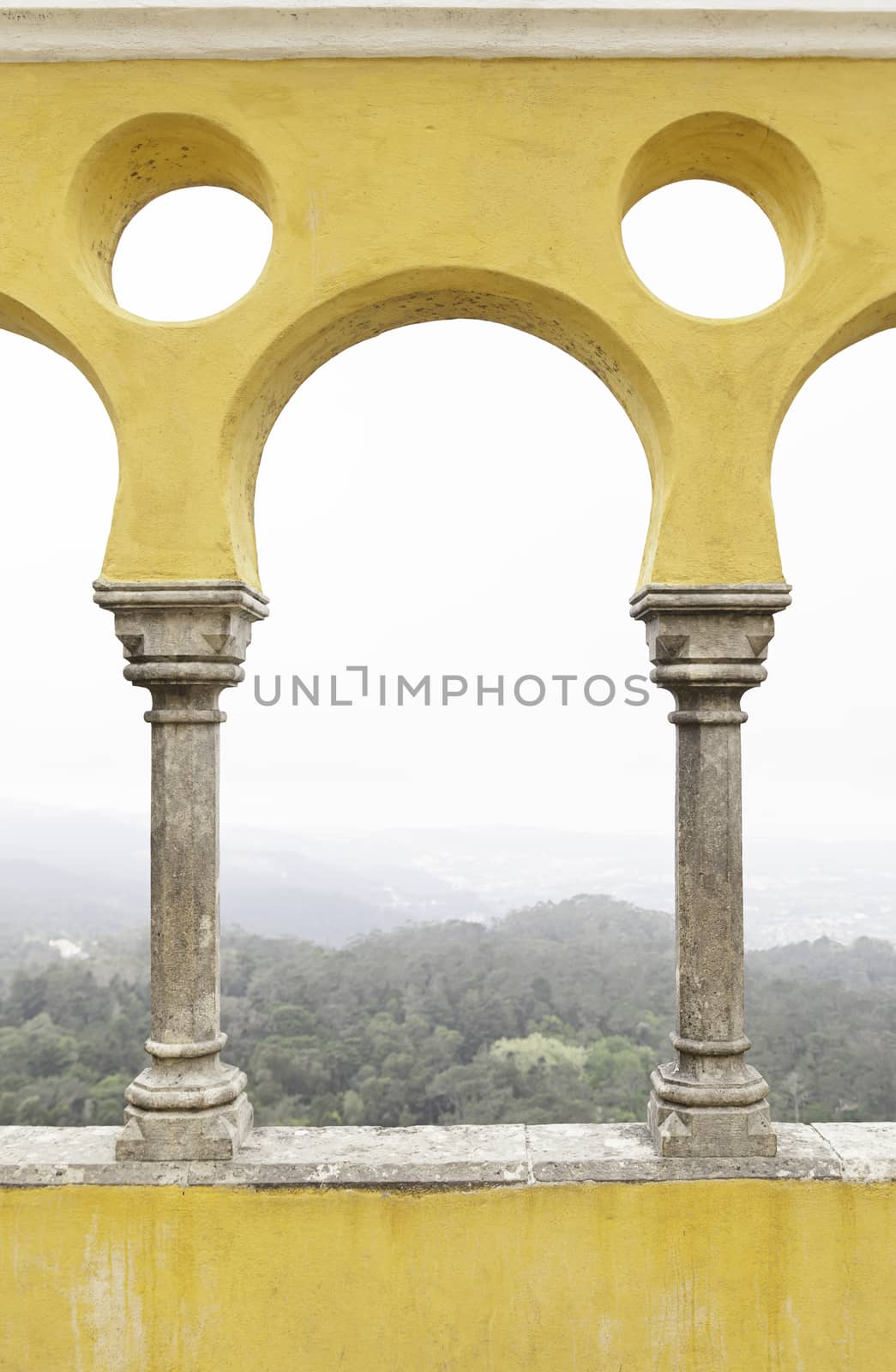 Ancient yellow arches in the Pena Palace, detail of ancient architecture, heritage of humanity, tourism