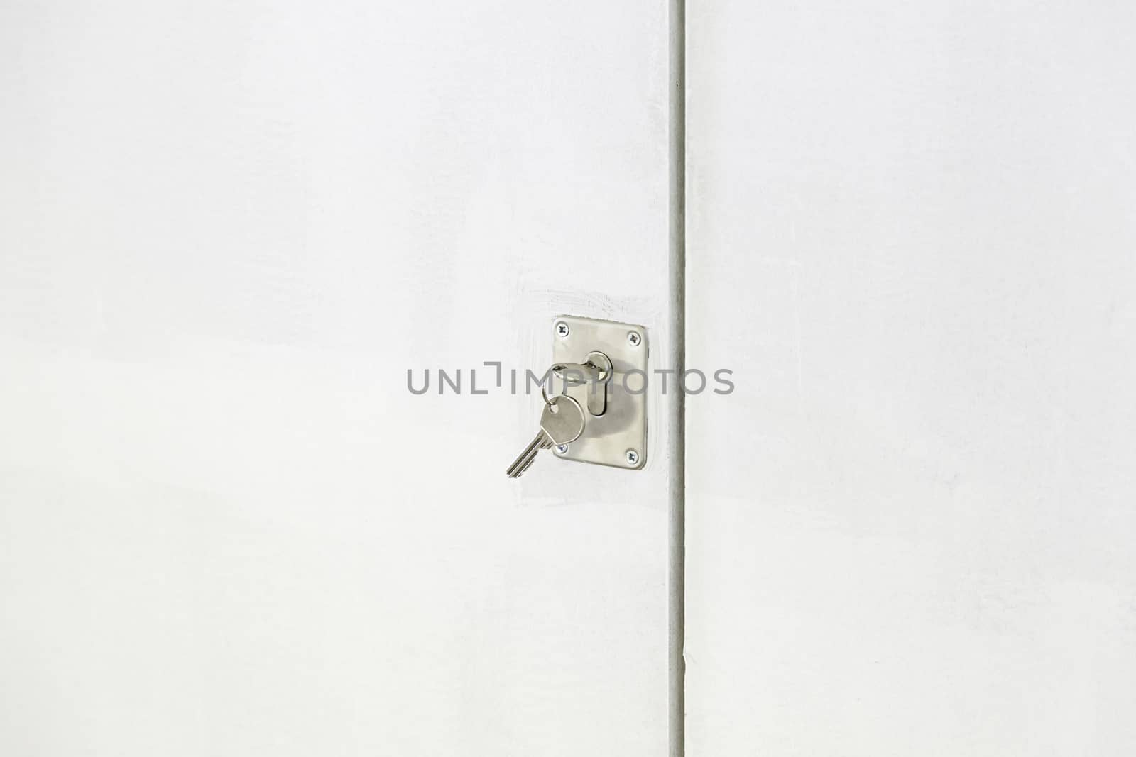 Key in a lock door, detail of a metal key in a lock, protection and security