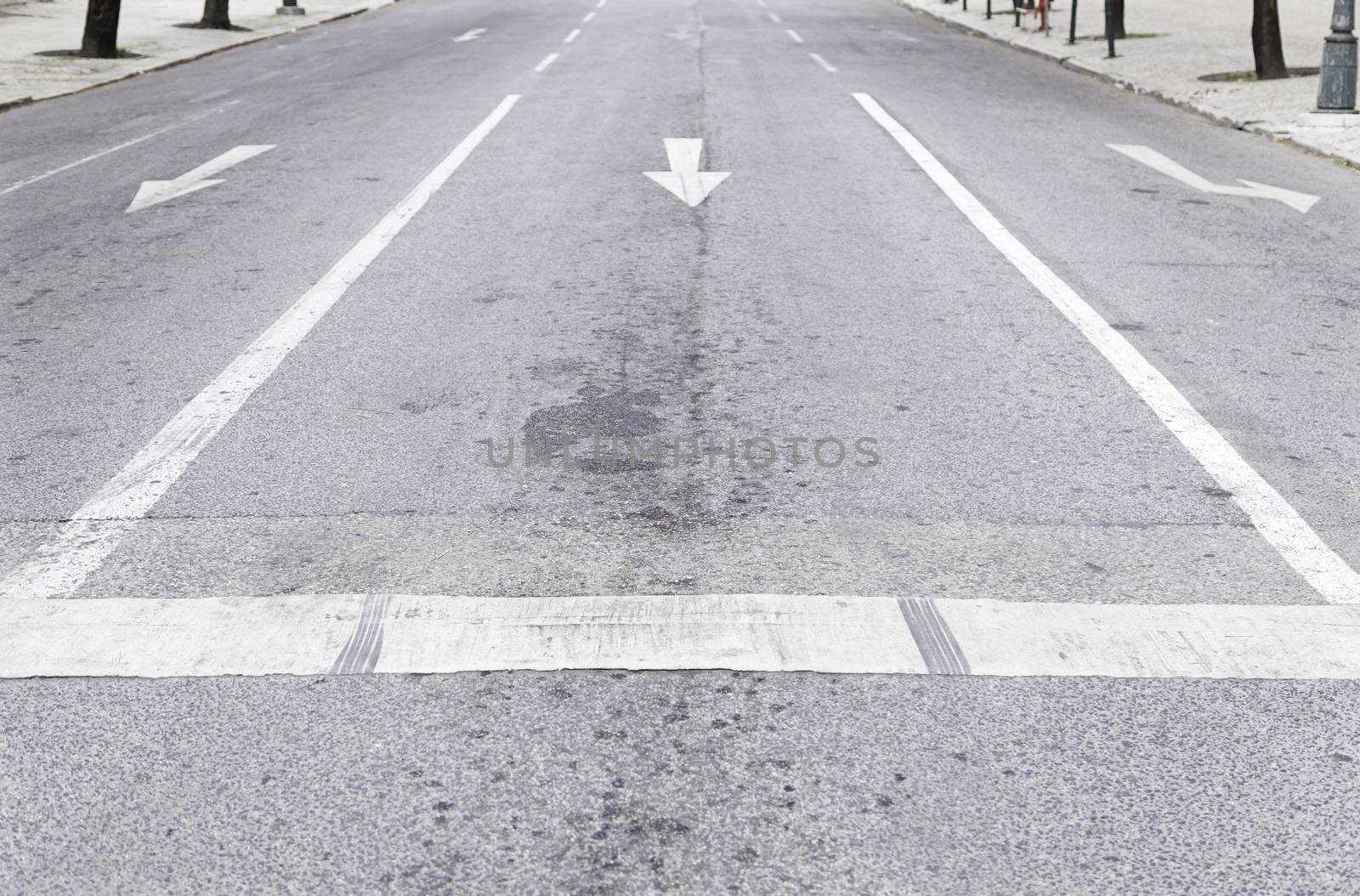 Arrow direction on asphalt, detail of an arrow of indexation on a highway, road information