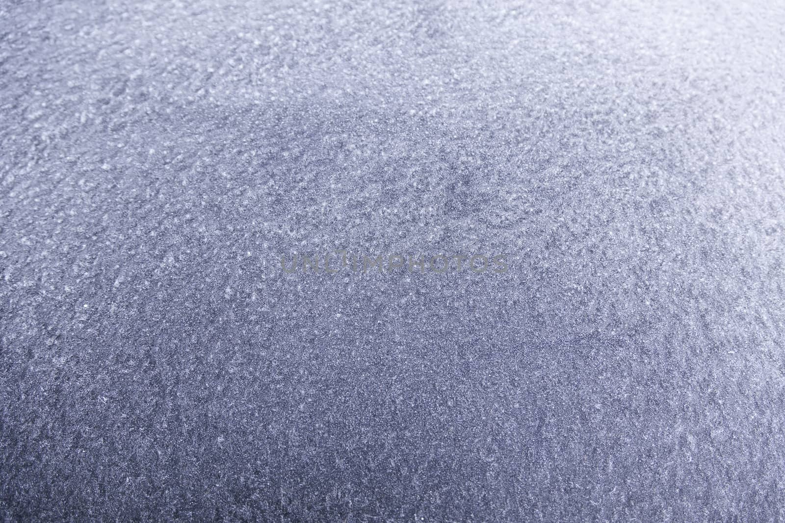 Blue ice on a wall, detail of a frozen wall, cold winter in the city