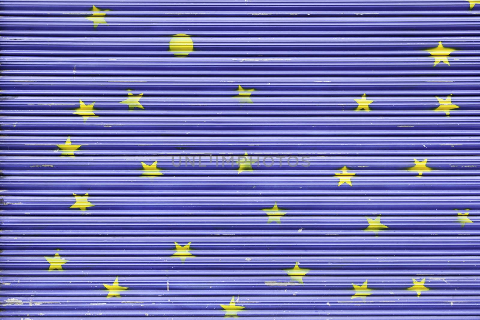 Blue painted metal gate, a gate detail with yellow stars painted decoration in the city