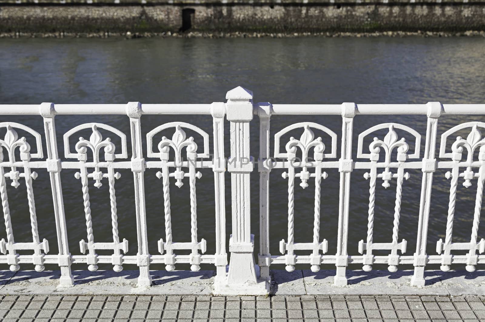 White metal railing, detail of a guardrail and decoration in the city