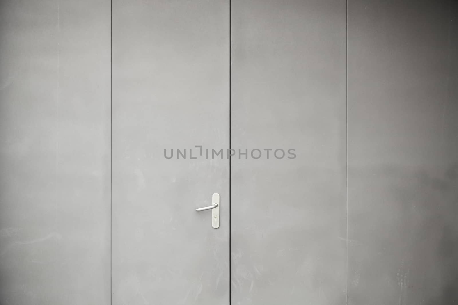 Gray metal door, detail of a closed metal door painted gray steel background texture