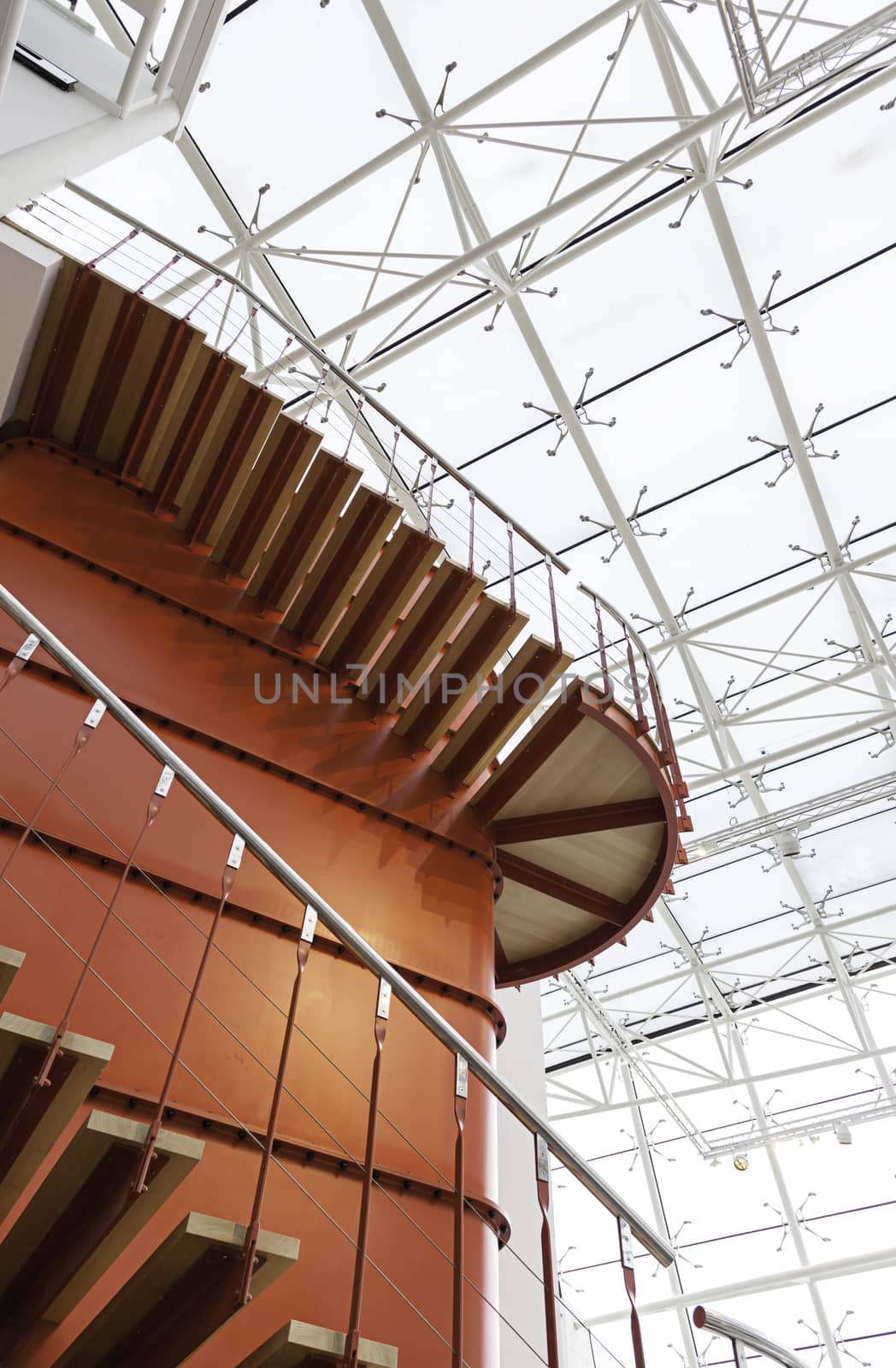 Red metal staircase, detail of a staircase inside an industrial building