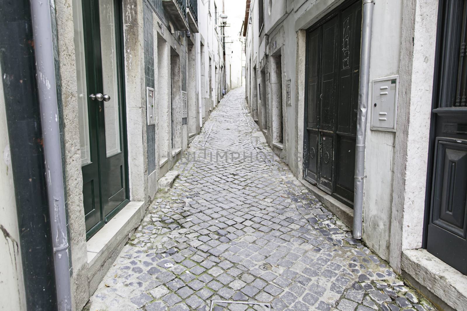 Old and historic alley in Lisbon, detail of an old street in the historical district, tourism in Portugal
