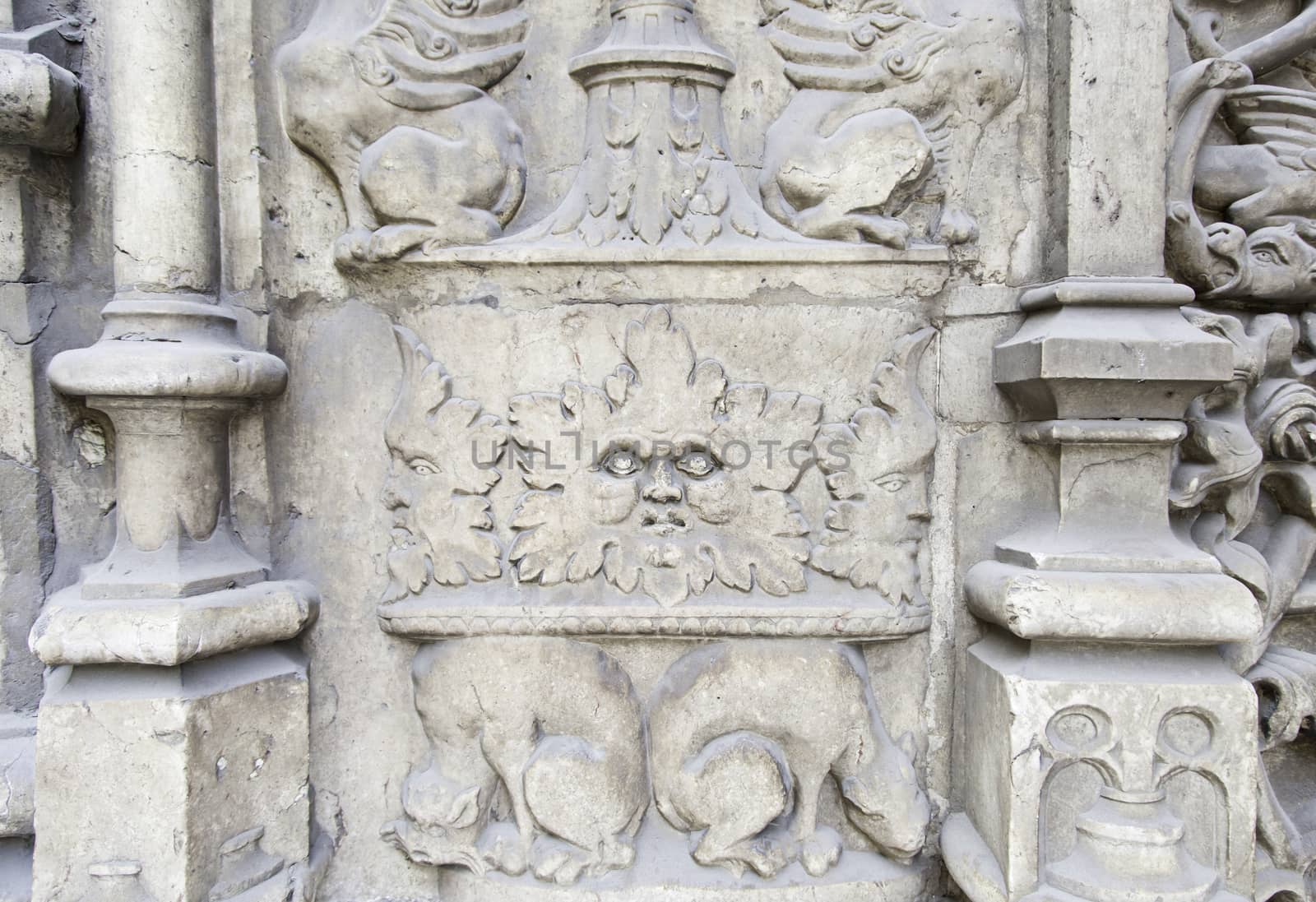 Carved stone figures, detail of a decorated stone wall, background with texture, monument
