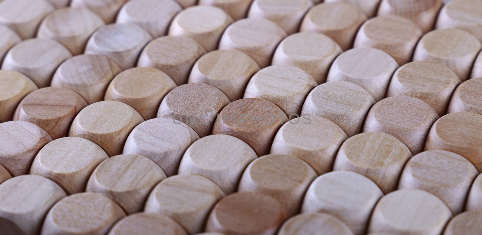 Close up background pattern of natural wooden dice shaped toy building blocks, high angle view perspective