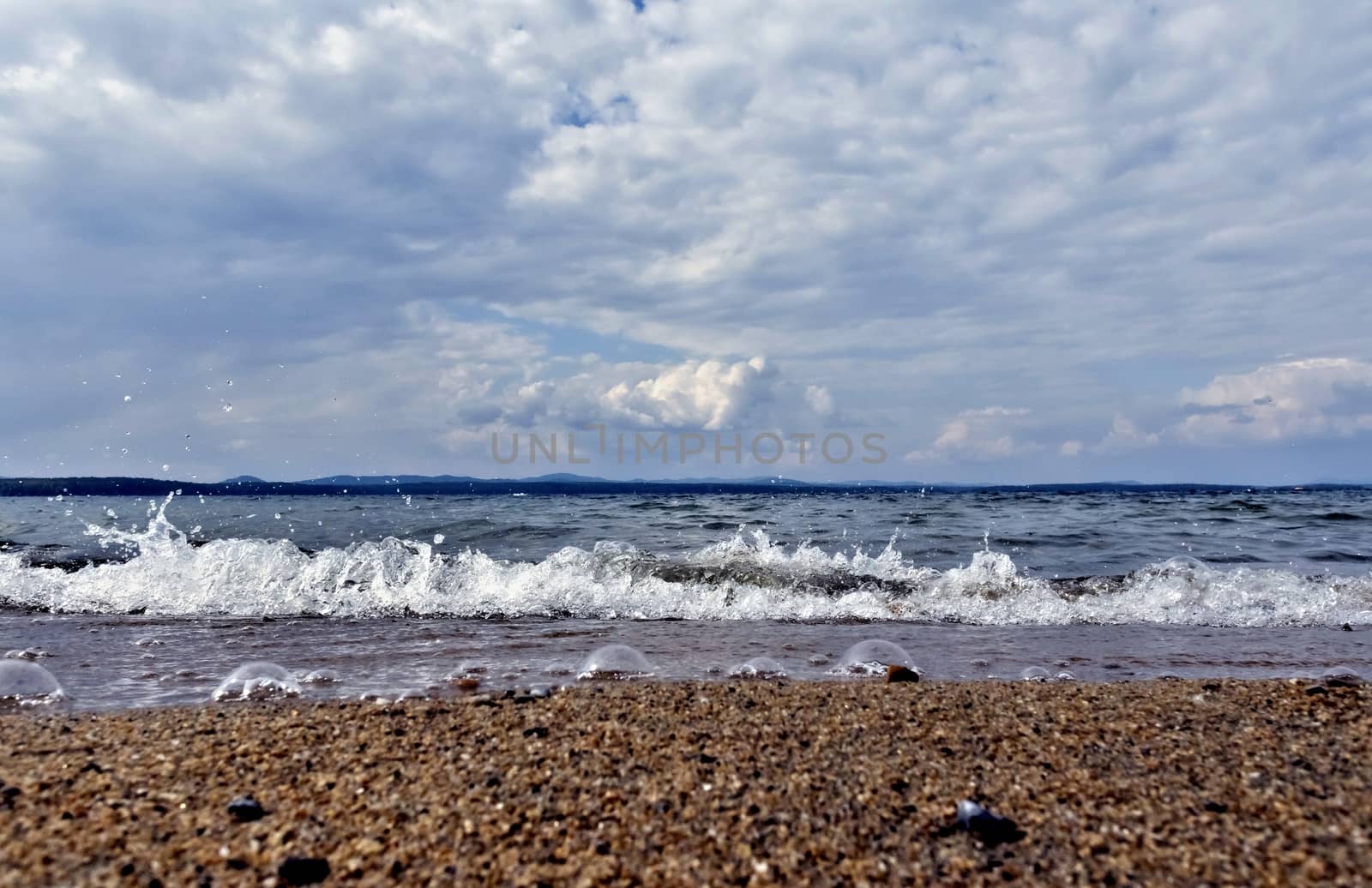 view of the lake with cumulonimbus clouds above it in windy weather, low point shooting