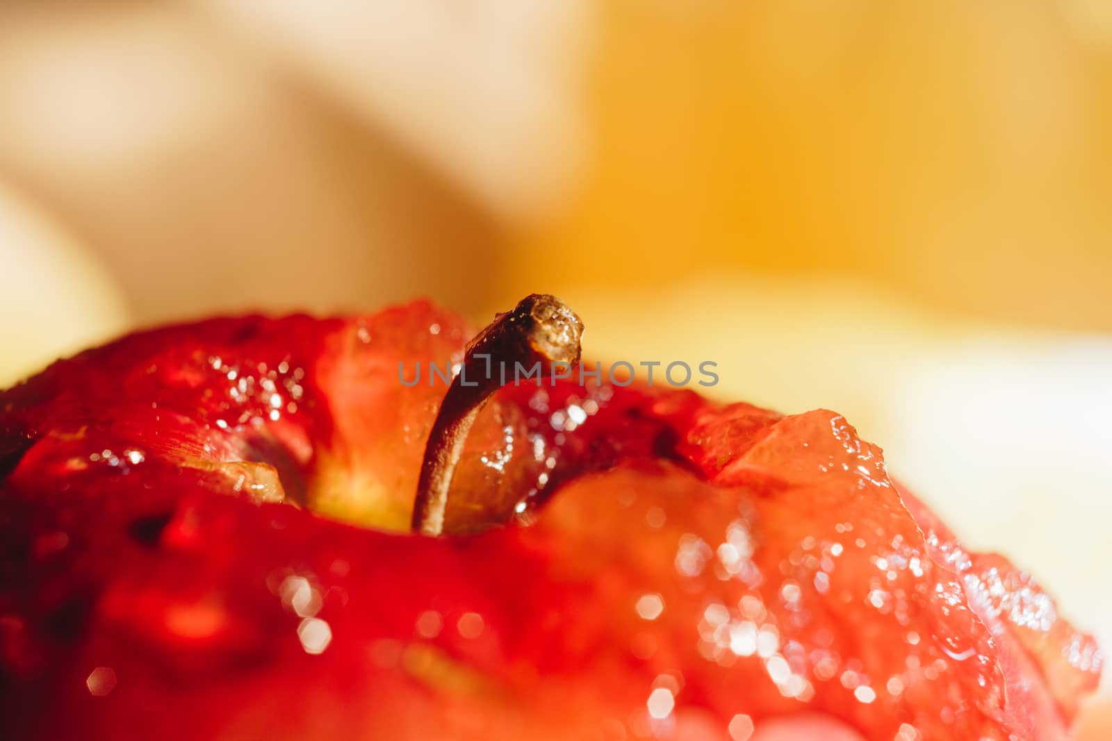 Honey with wooden honey dipper paper napkin and fruits on wooden table close up by yulaphotographer