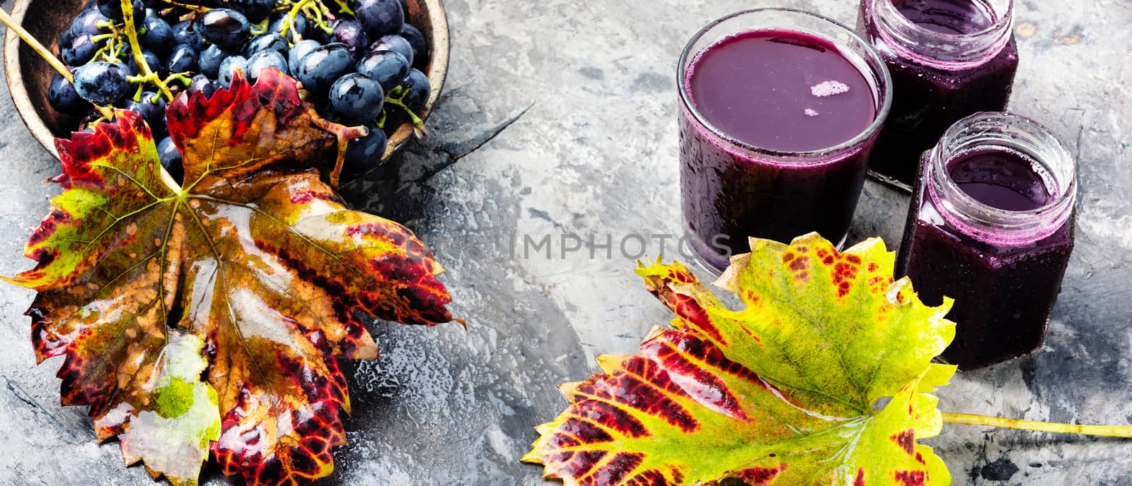 Red grape juice in glass and grape fruit.Long banner