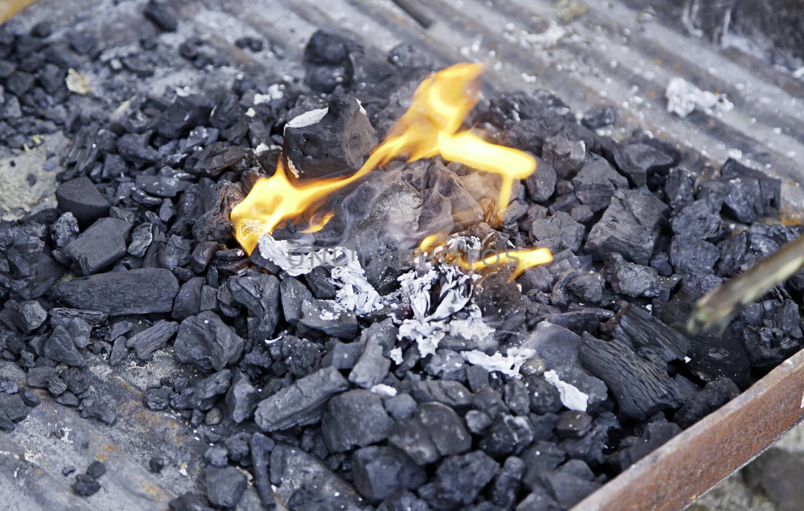 Embers of coal with fire, detail of a grill for grilling meat, ancient tradition, food