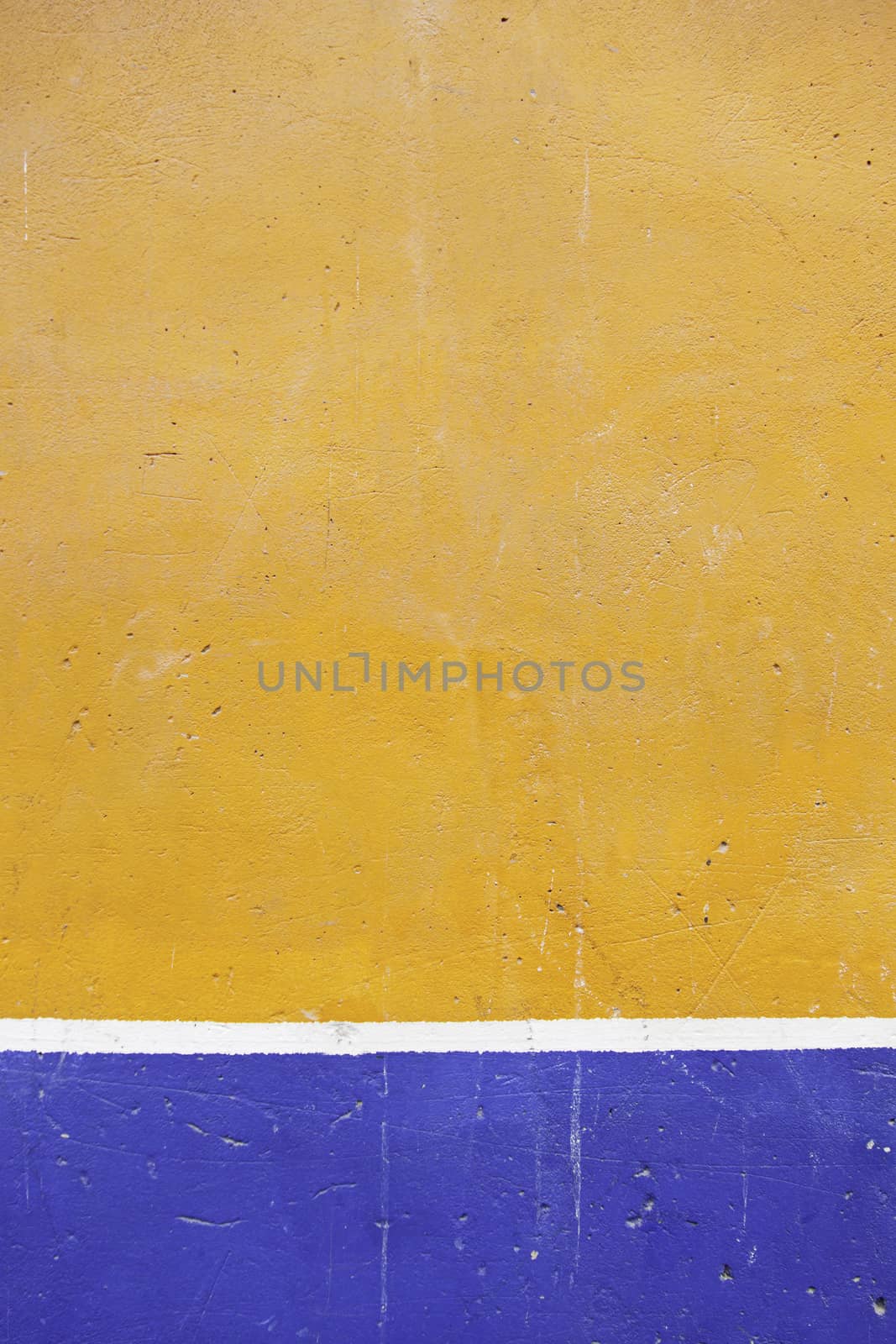 Painted cement wall, detail of a wall orange and blue textured background decorated