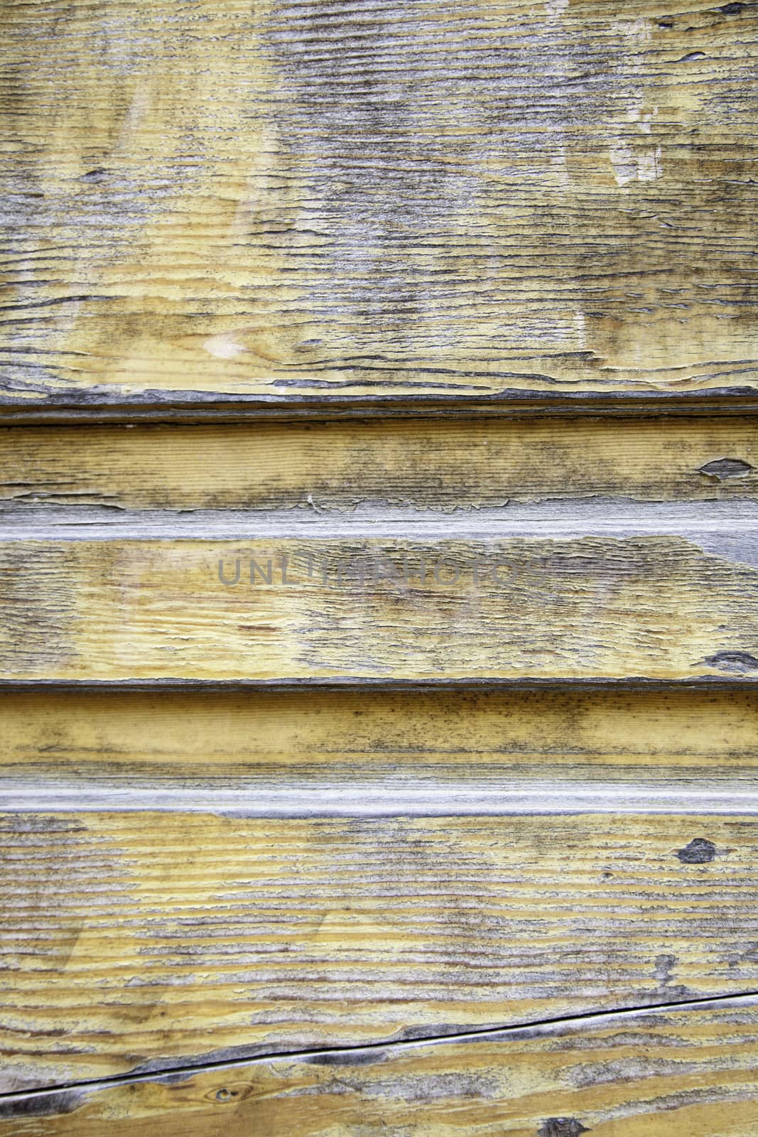 Broken wood, detail of a wall decorated with old wood, paint and mold