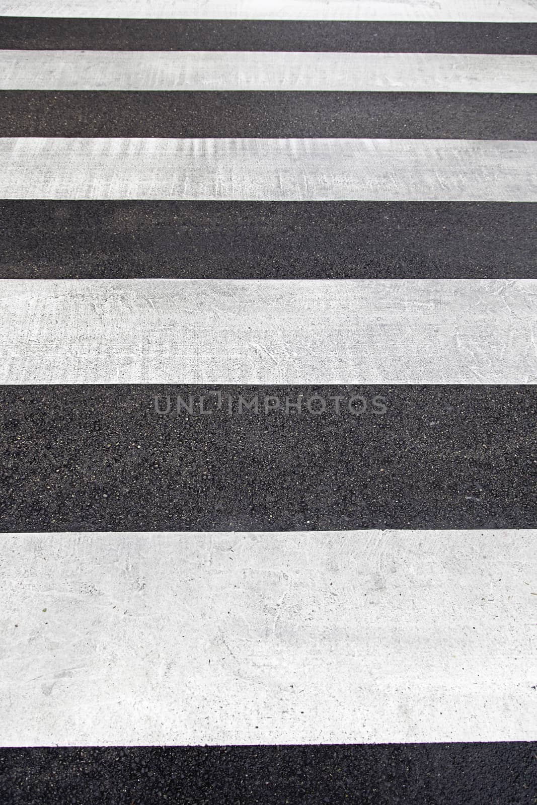 crosswalk urban detail some indication lines on the asphalt, textured background, road safety