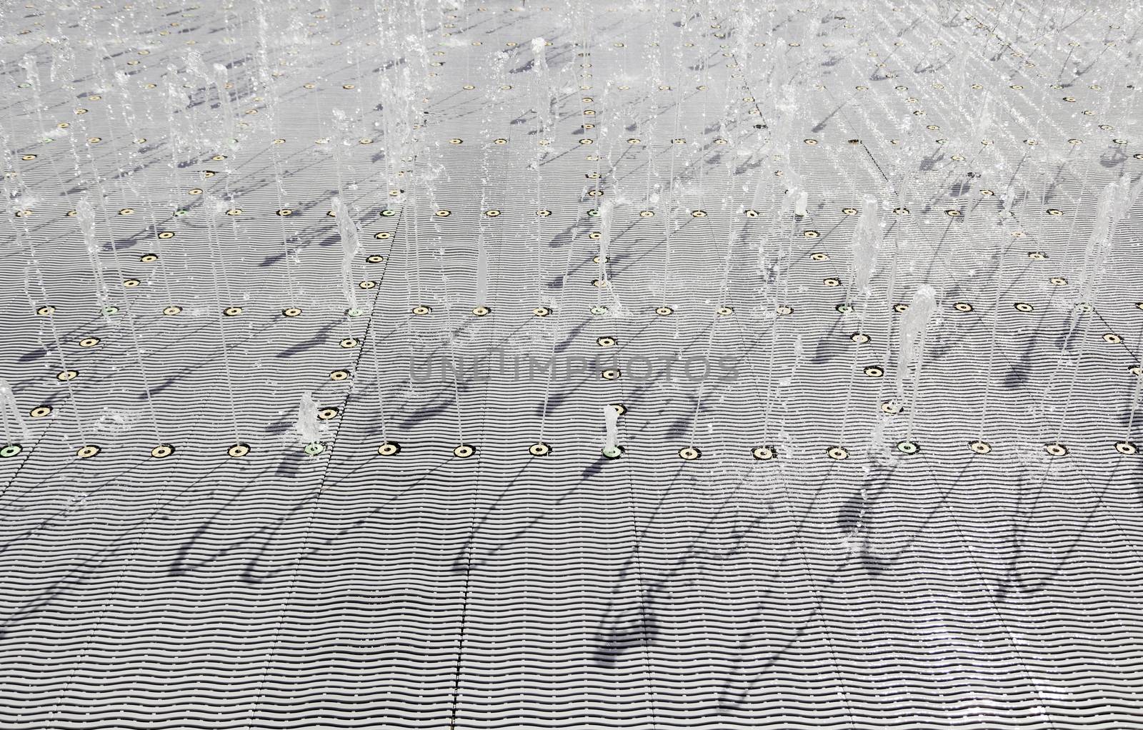 Fountain of water to play, detail of a water maze, summer games