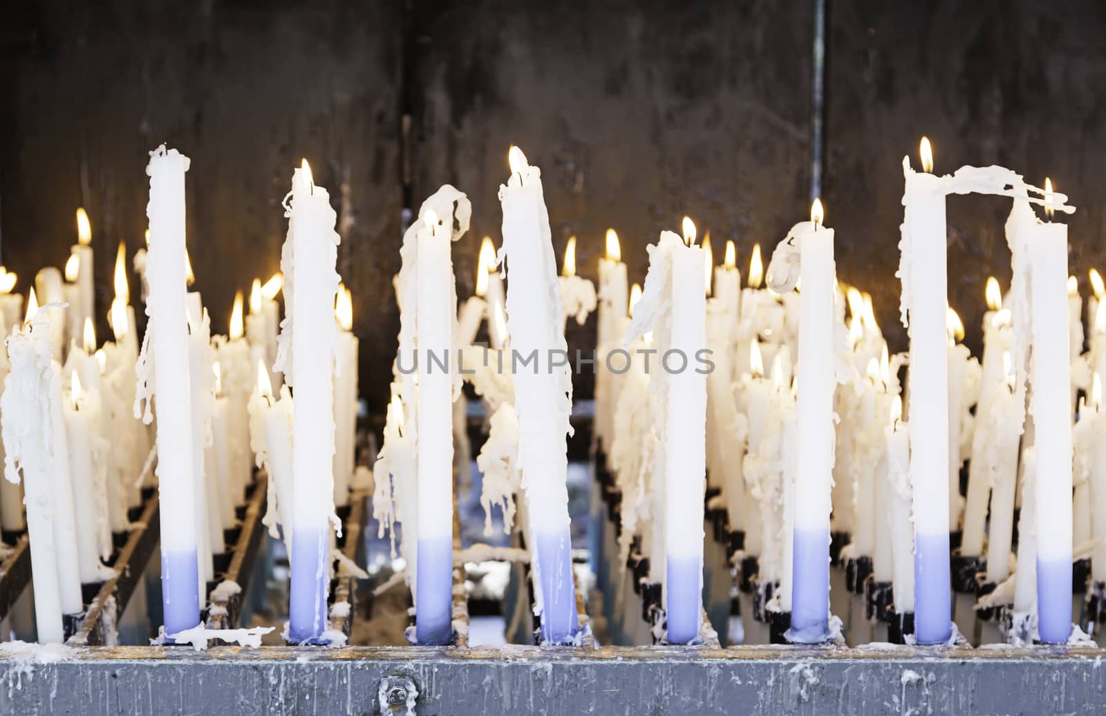 Church candles lit, detail wax candles Christian prayers, belief and faith