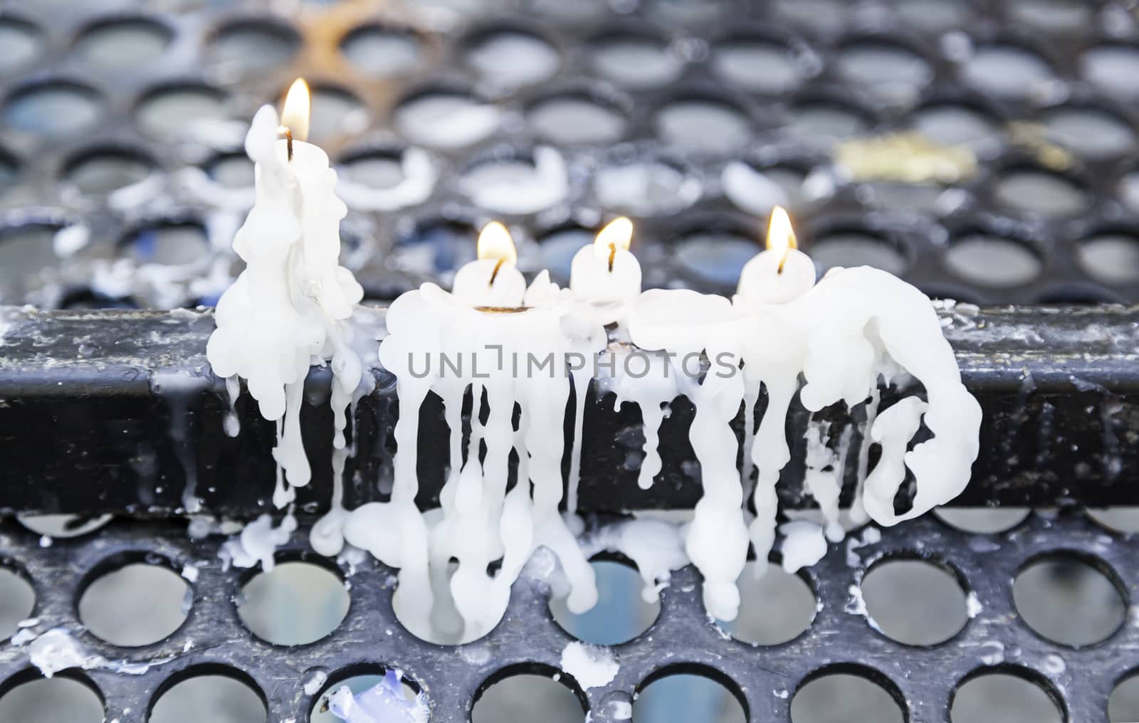 Lying lit candles, wax candles detail dripping wax, belief and faith, religion