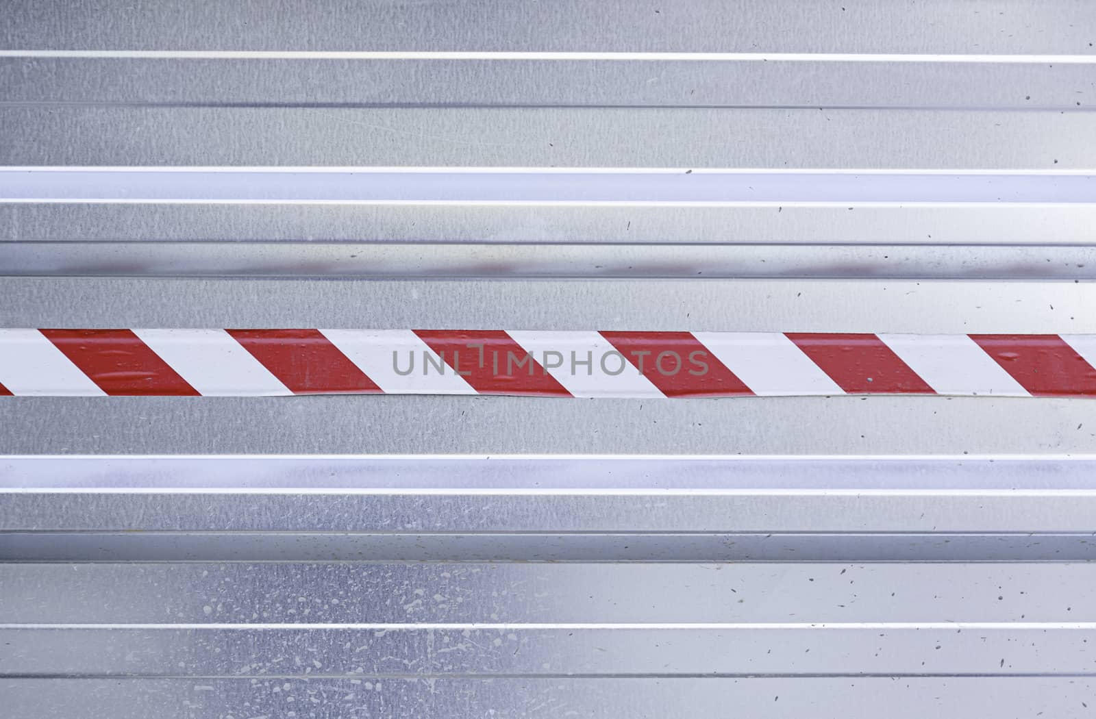 Metal background with warning sign, detail of a metal wall with hazard information