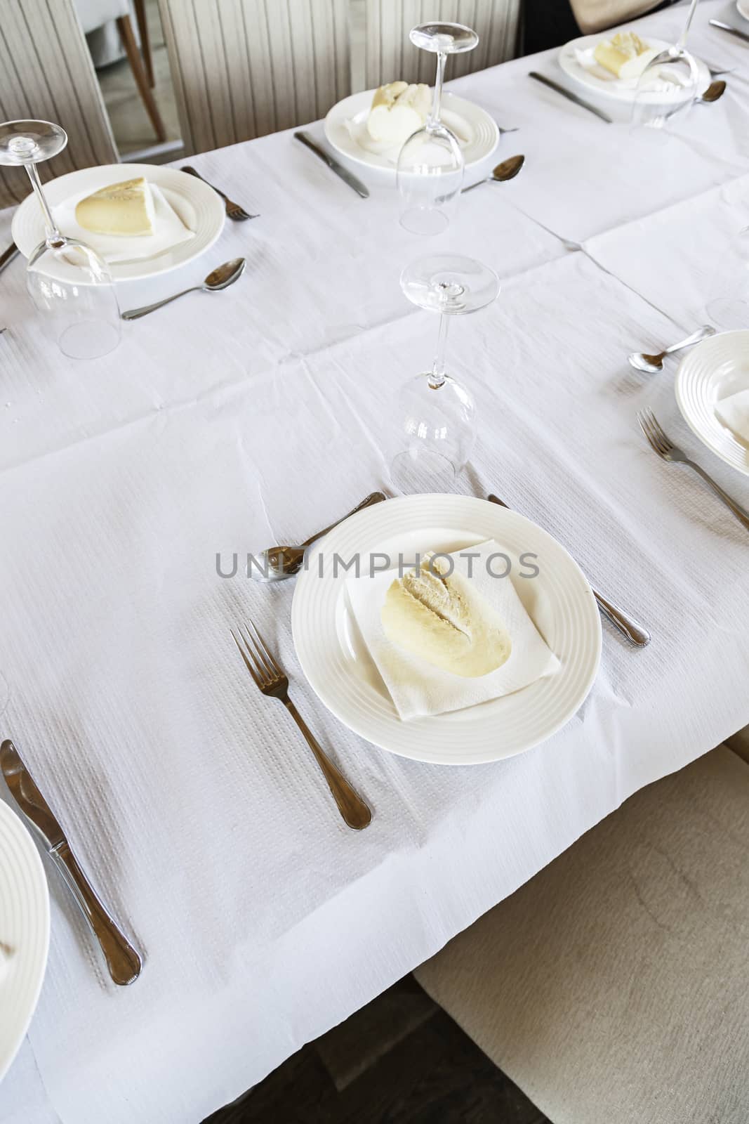 Restaurant table to detail of a dining table, dishes and silverware for food