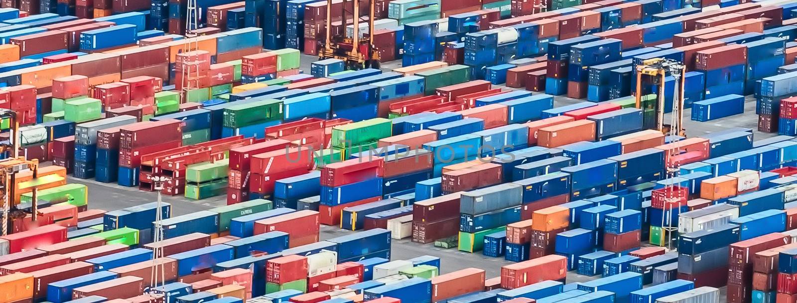 Aerial view over shipping containers stacked on a commercial por by marcorubino