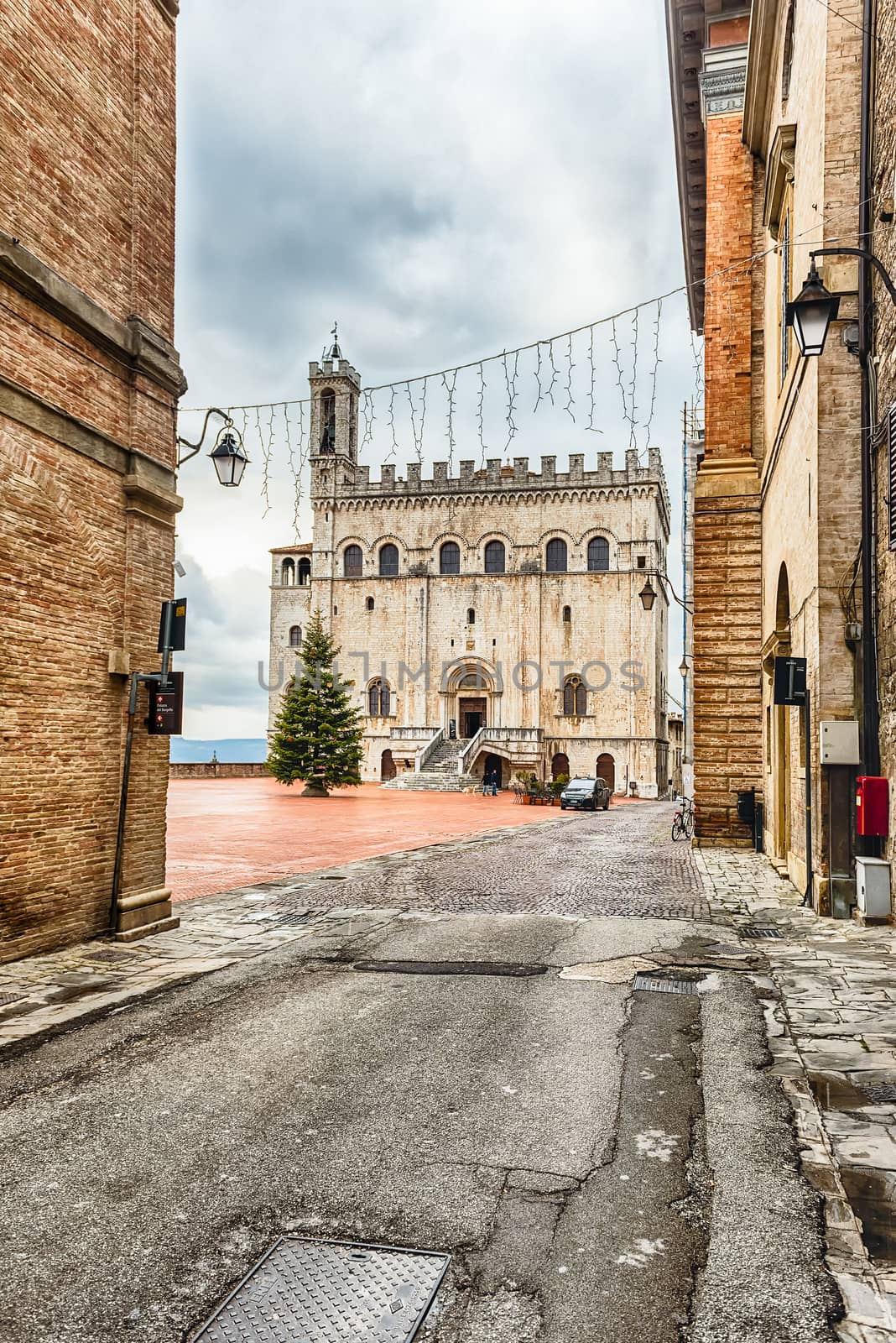 View of Palazzo dei Consoli, a medieval building facing the scenic Piazza Grande in Gubbio, Umbria, central Italy. It is house to the local Civic Museum