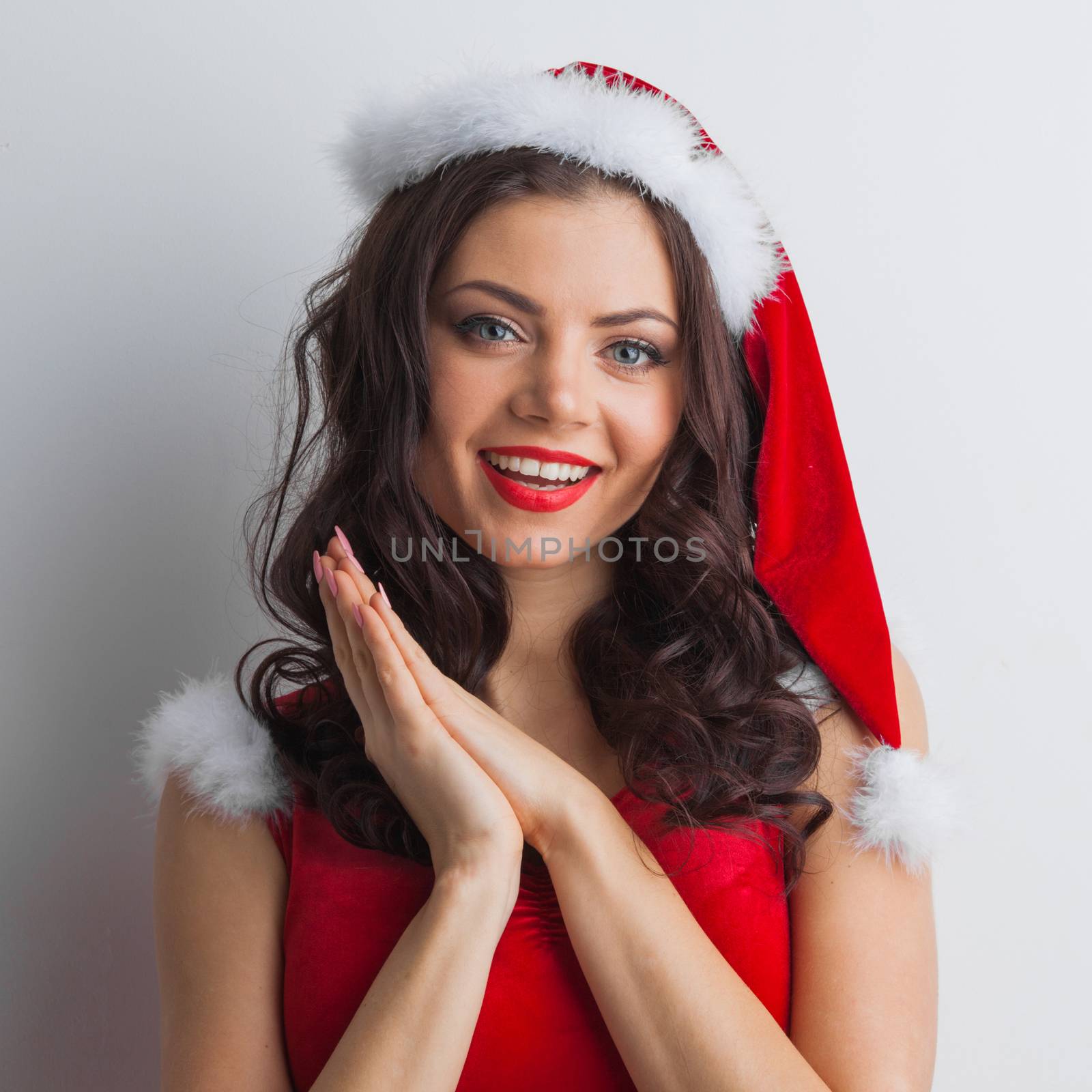 Pretty Pin-up style Santa girl in red hat on white background